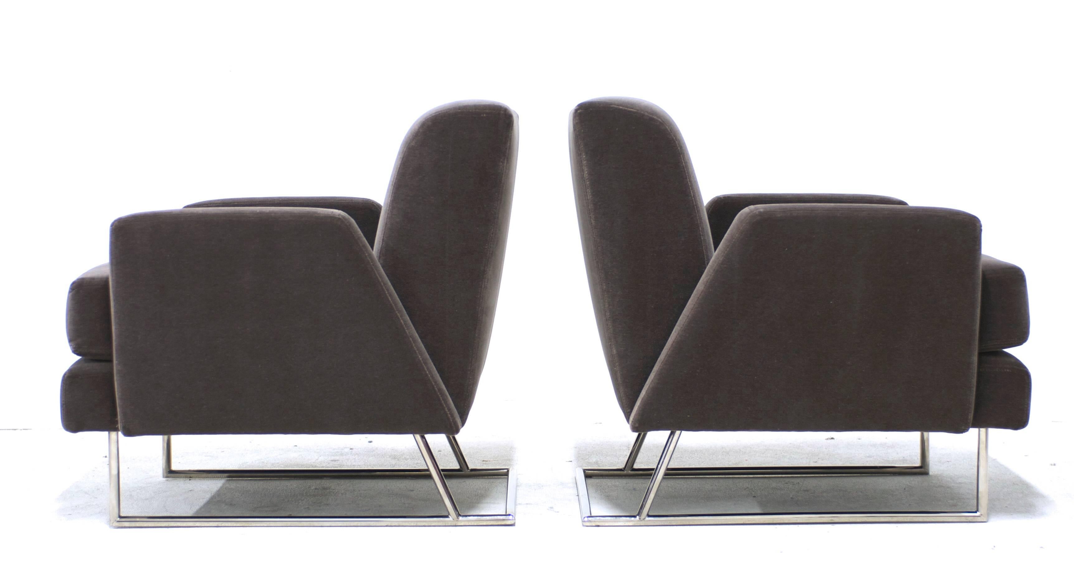 In the style of Paul Tuttle this Postmodern pair of lounge chairs have been reupholstered in a luxe deep taupe mohair the color of Weimaraners. The polished steel bases have a nice sculptural angle at the back which follows the line of the back of