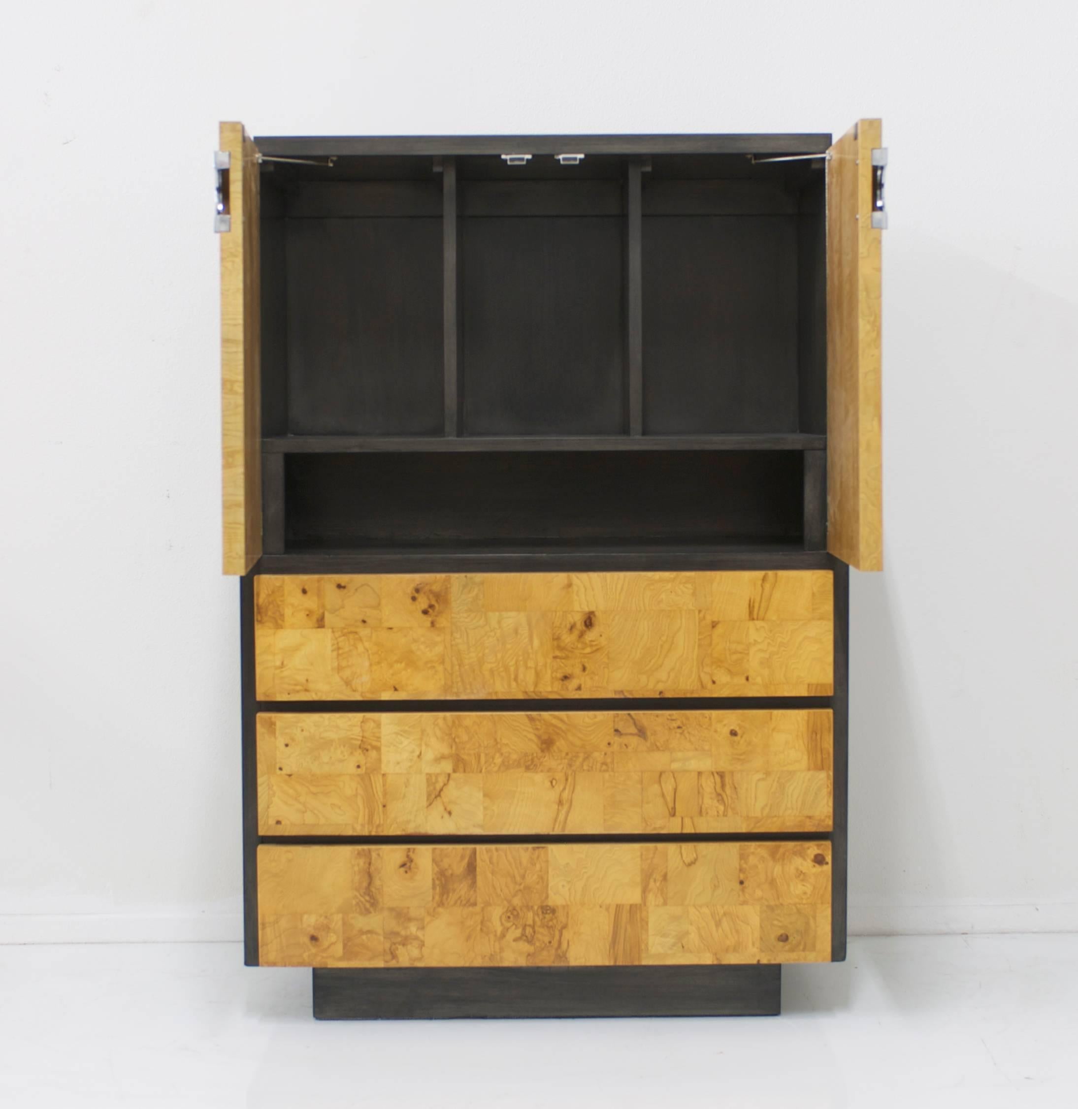 This tall chest by Lane Furniture has three Paul Evans style patchwork burl wood front drawers at the bottom and two top door fronts fitted with dividers on the inside. Ideal for storage or would make a handsome dry bar. The top and sides of the