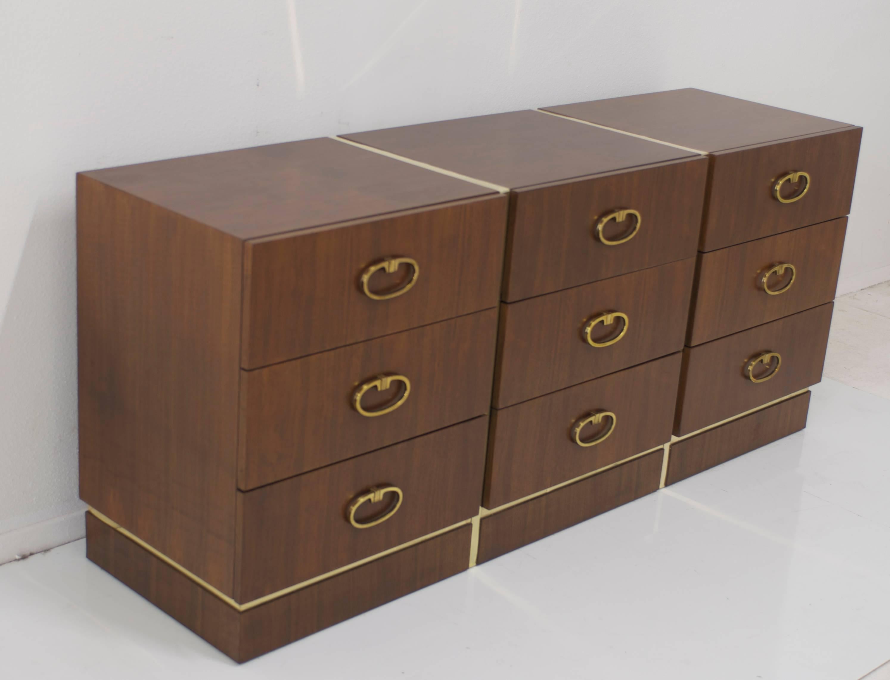A restored dresser that is in excellent vintage condition. The brass strips go around the front sides and top of the cabinet. The piece is comprised of nine drawers each with the original brass pulls.
 