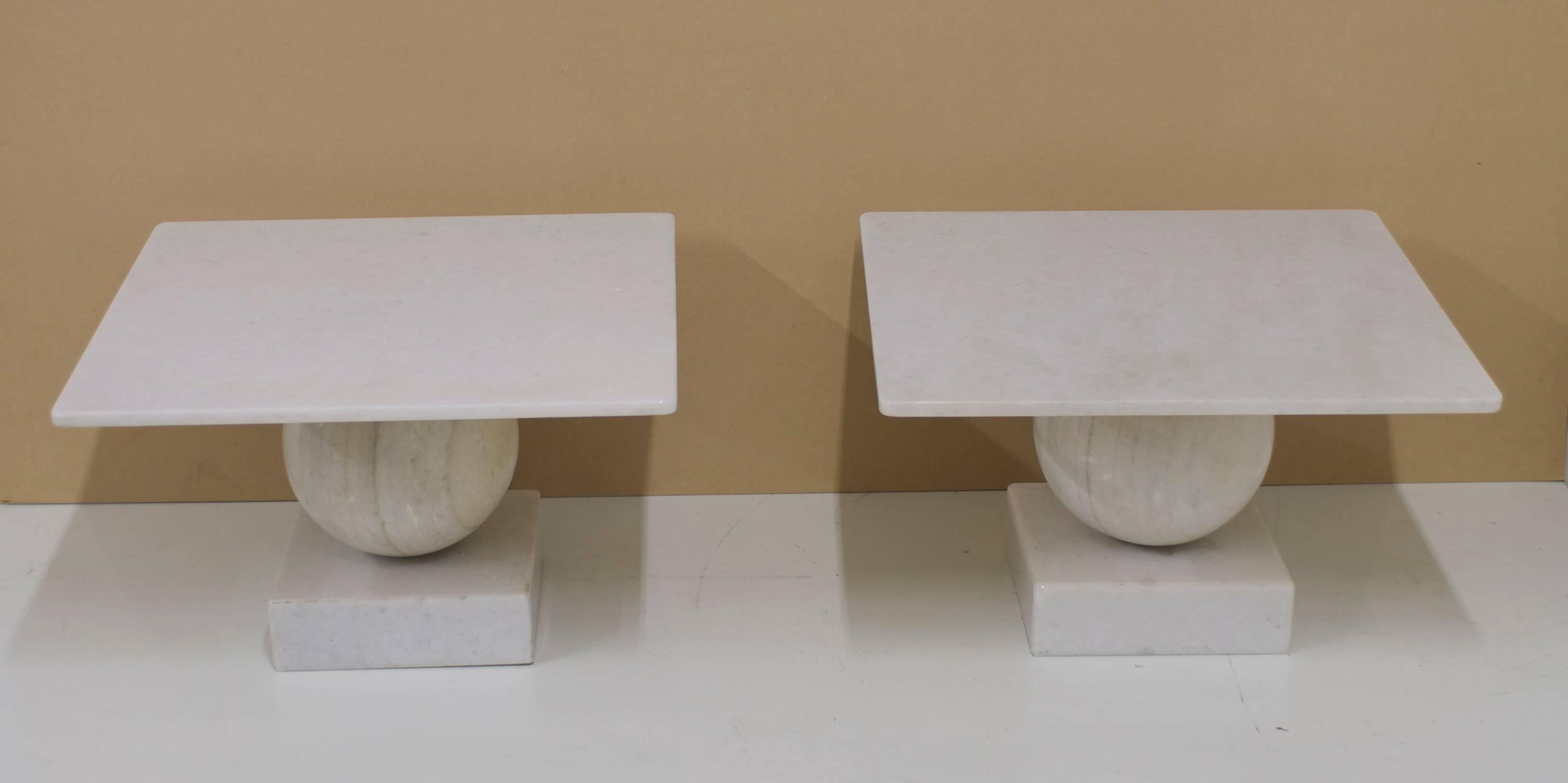 A pair of custom solid marble side tables made of geometric forms. A solid marble ball rests on a square base. The 30