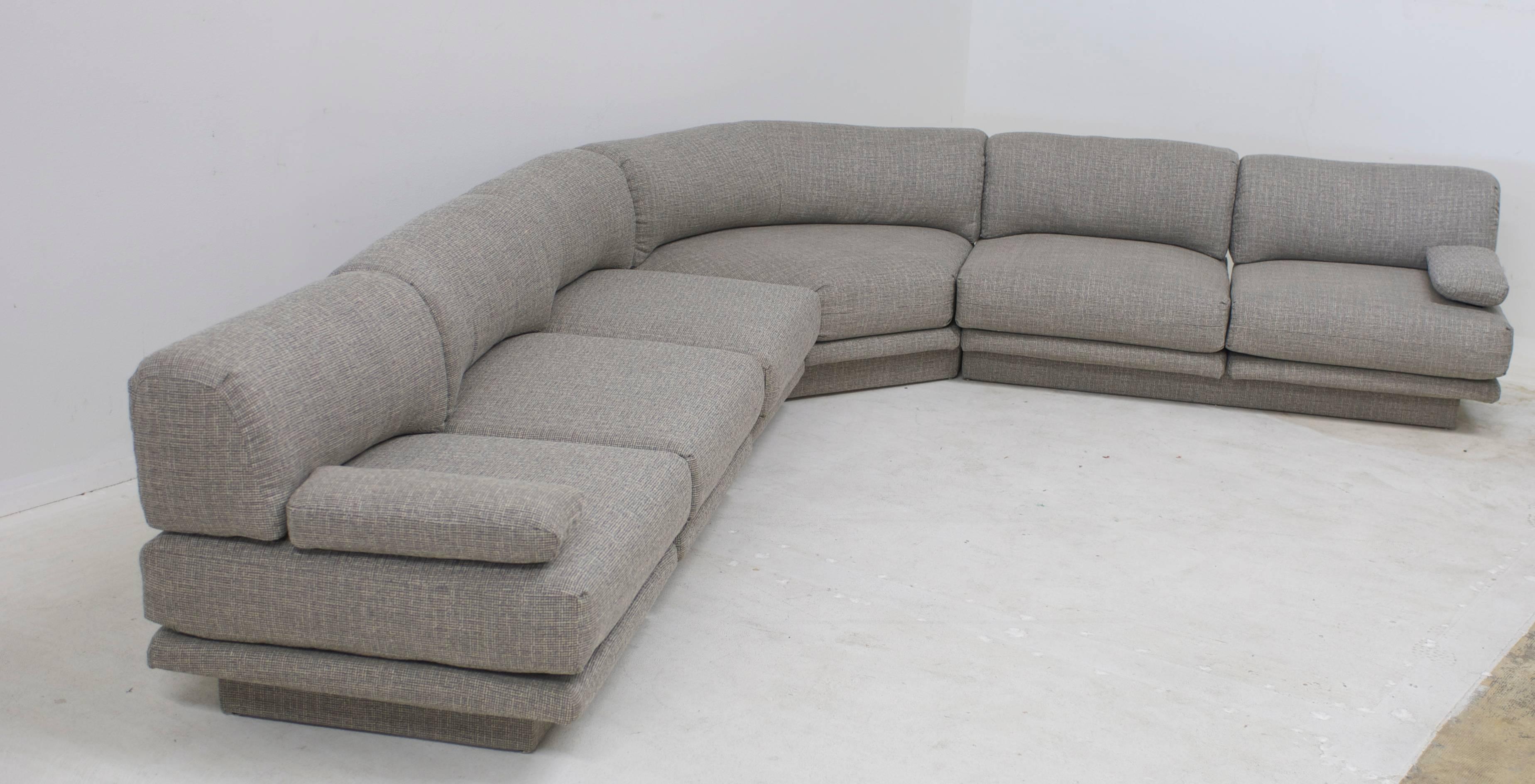 With a nod to the 1970s era of Courreges fashion and the style of Pierre Cardin and De Sede, this low slung versatile sectional can be configured in multiple ways. As shown in the photos, an L a U or a straight long sofa can be achieved if you take