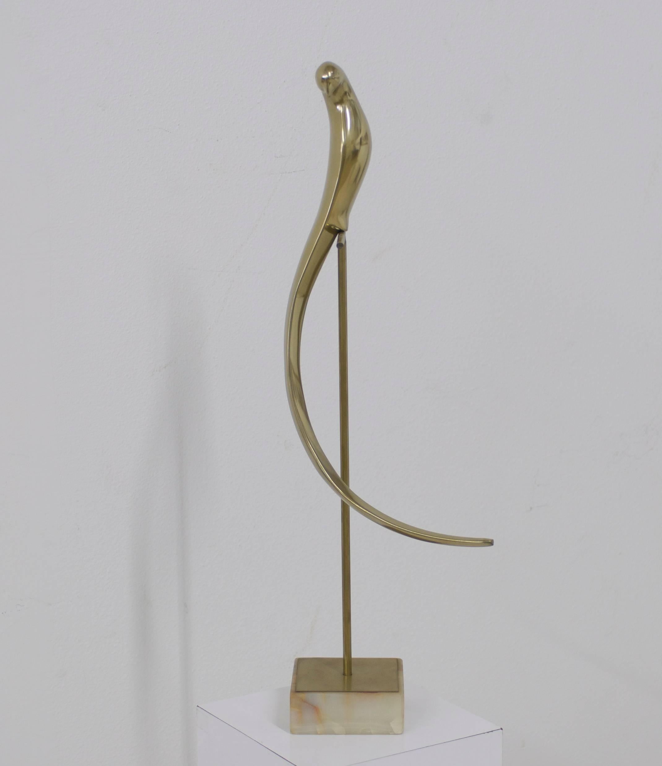 Beautiful brass bird sculpture mounted on an onyx marble stand. We had it professionally polished.
The base measures 5