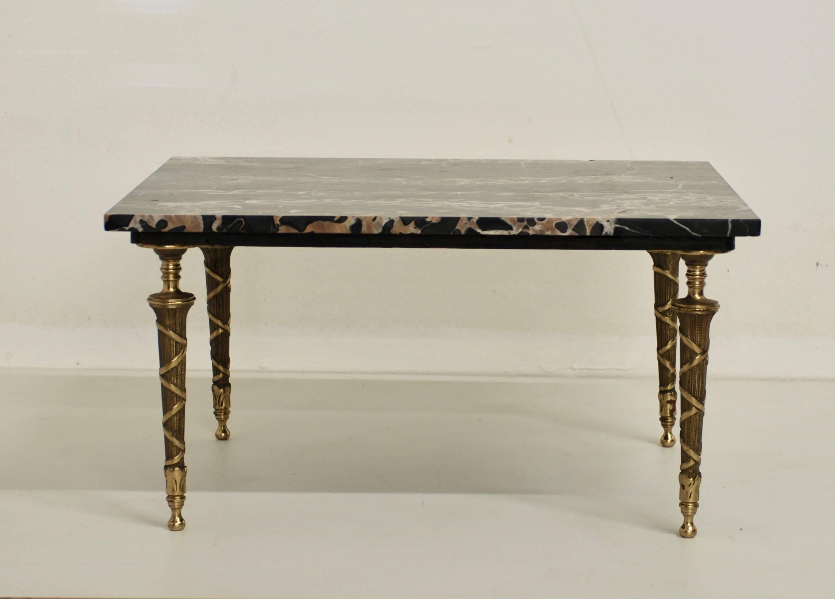 This low marble and bronze side or petite coffee table has stunning black marble with nice veining throughout. The marble sits on top of neoclassical styled bronze legs.
The marble top has been recently professionally restored and polished. 