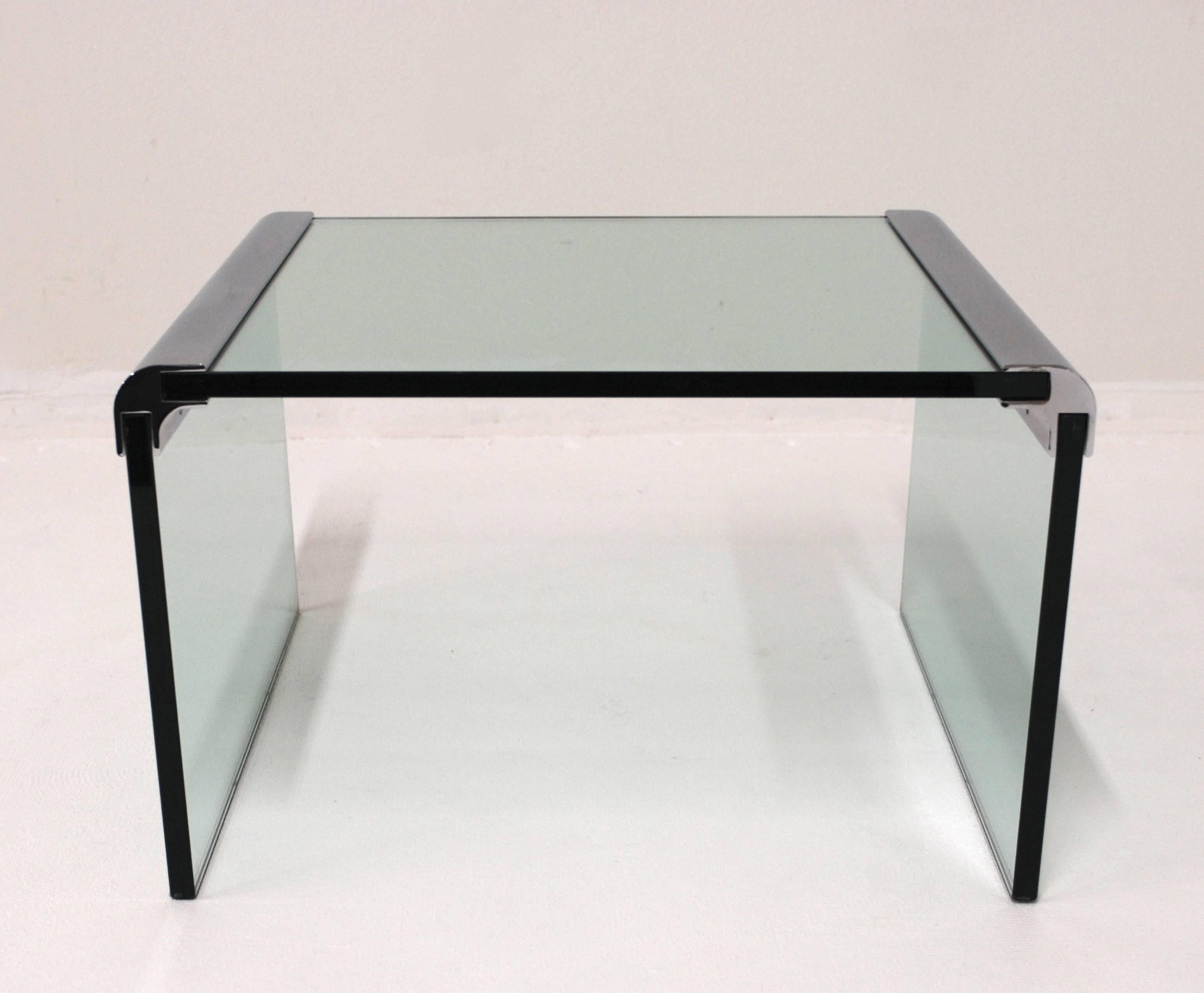 A Leon Rosen for Pace Side table that is in excellent condition.  The table consists of three sheets of 3/4" glass held together by chromed bars.  We have a pair of matching smaller side tables that work with this table to make a set, see last