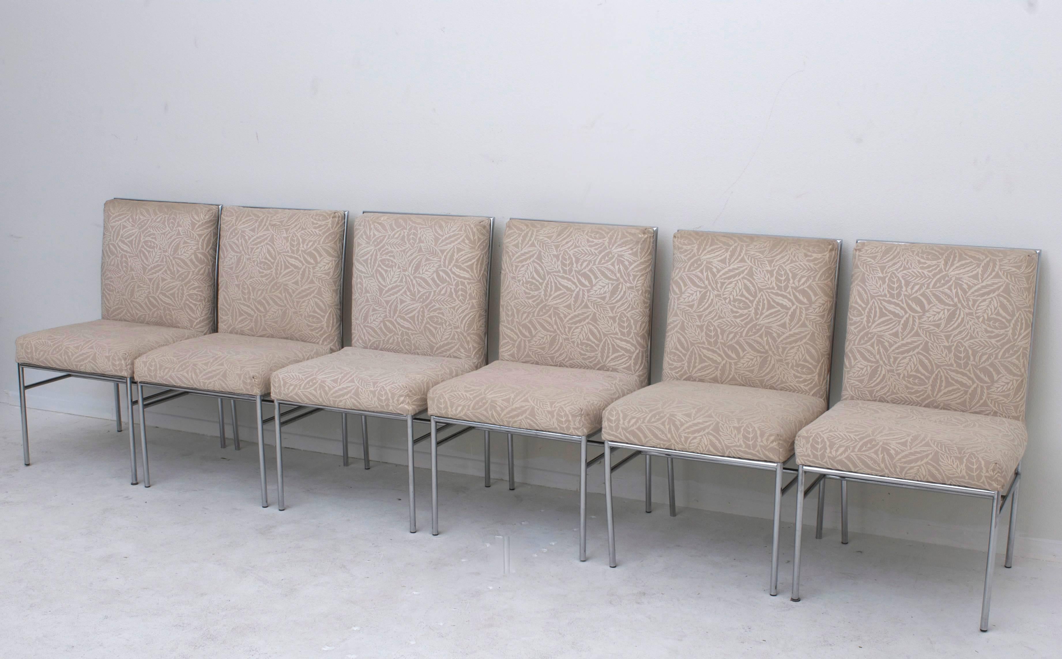 A set of six 1970s era high back dining chairs with chromed tubular frames. The upholstery is vintage.