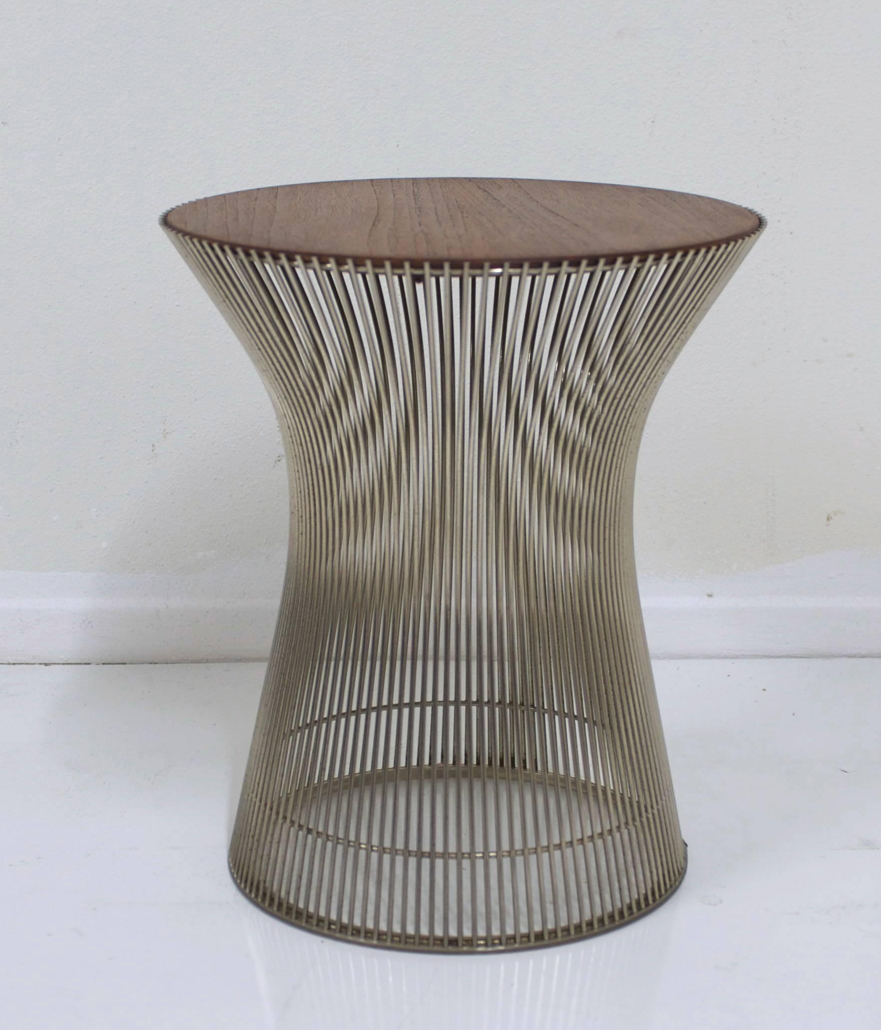 An early Warren Platner designed side table manufactured by Knoll with a medium to light toned nicely figured walnut top. The table retains its original base protection piece. Base is 13" Made in Italy for Knoll. 
From Knoll: In 1966 the