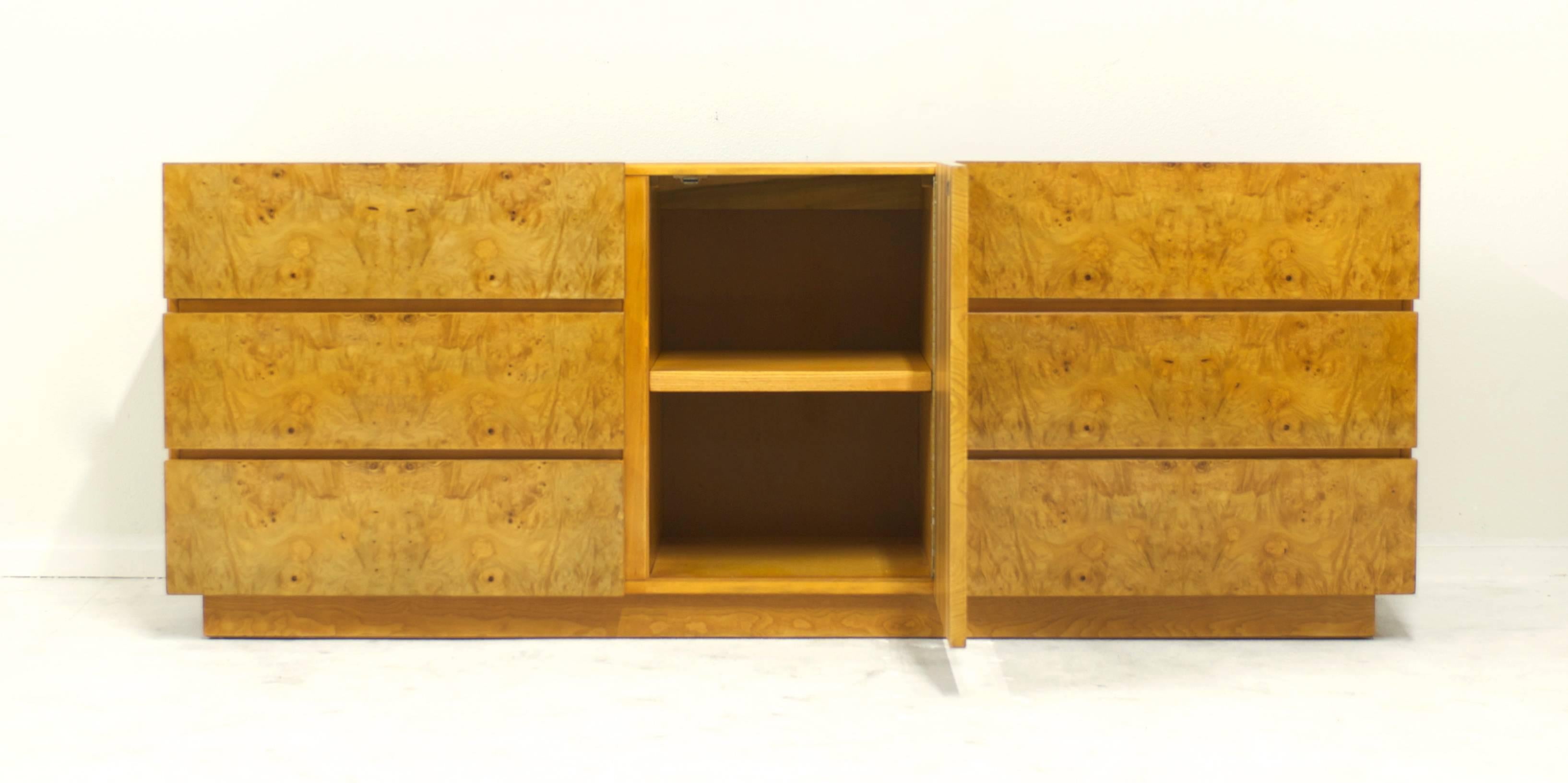 A dresser or cabinet designed by Milo Baughman for Lane Furniture Co. The piece has nicely figured olive burl wood door and drawer fronts. The side and top is made of wood veneer. The right and left side of the dresser has three drawers each for a