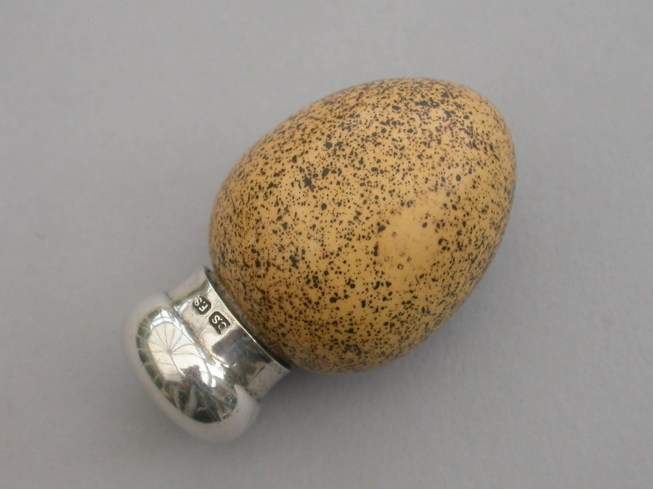 A good Victorian novelty silver and McIntyre ceramic scent bottle made in the form of a Wrens Egg, with screw-off silver top and of small size. The egg stamped with a registered design number: 20772.

By Saunders & Shepherd, Birmingham, 1896

In