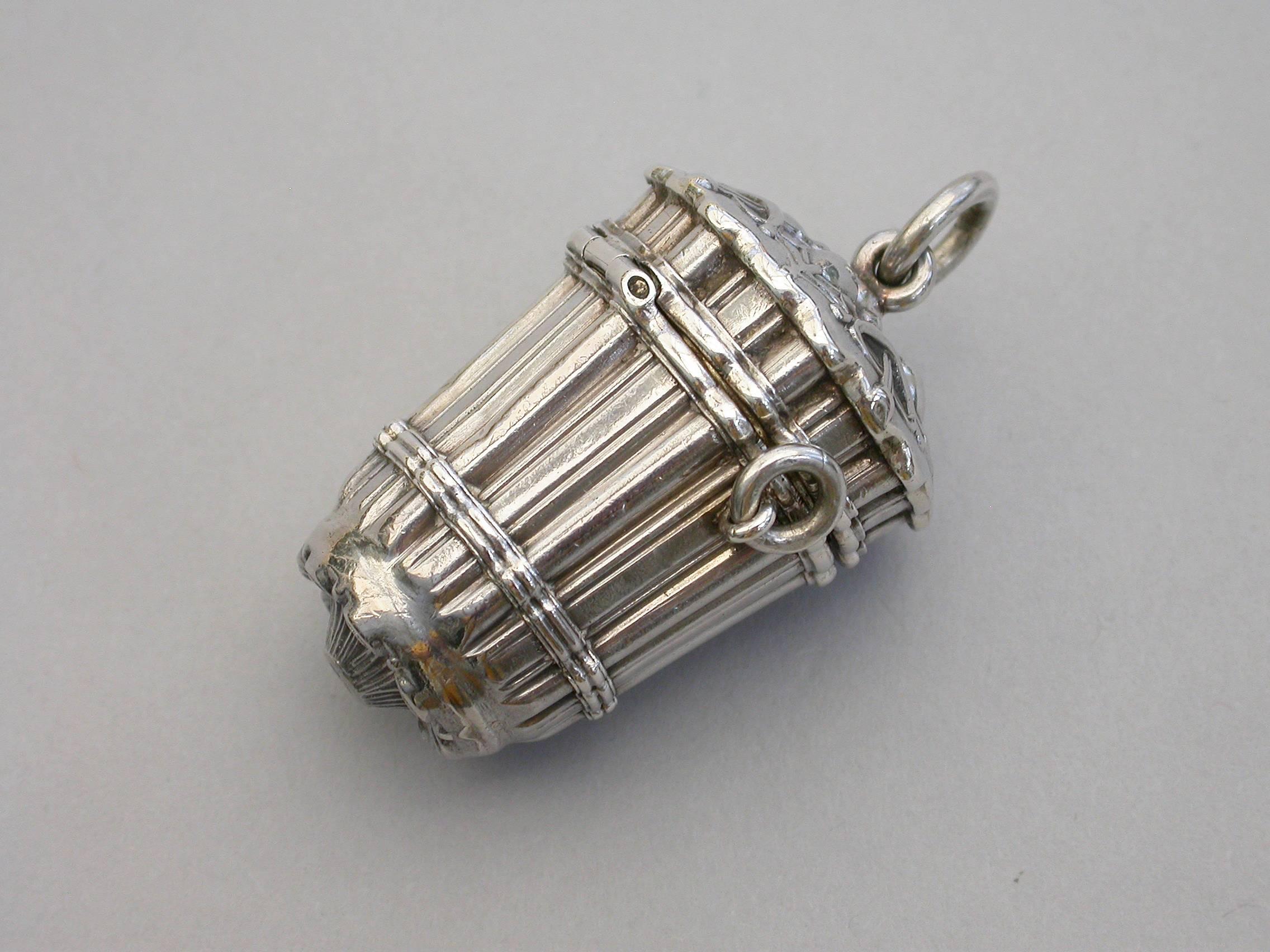 A rare Victorian novelty silver vinaigrette formed as a pannier of vertical reeds or straw bundles woven together, hinged at the shoulder with decorated lid and base, a pair of small rings to the sides and larger suspension ring to the lid. The