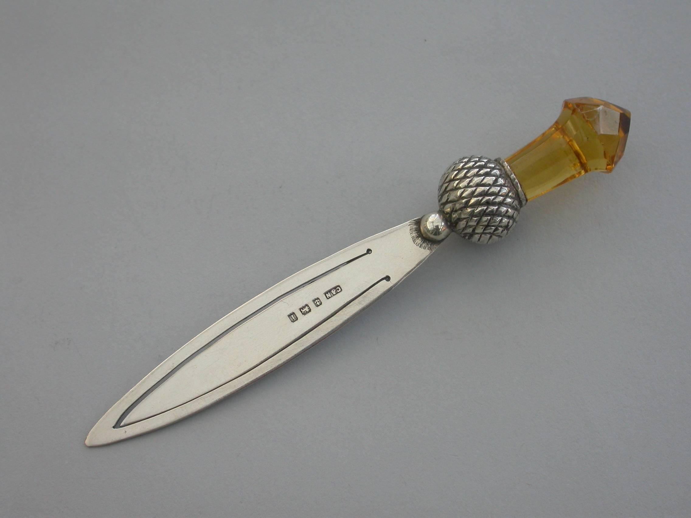 A good Edwardian silver bookmark with plain dagger shaped blade, the terminal set with a carved Cairngorn stone in the form of a thistle.

By Crisford & Norris, Birmingham, 1908

In good condition with just extremely minor flea bite chips to the