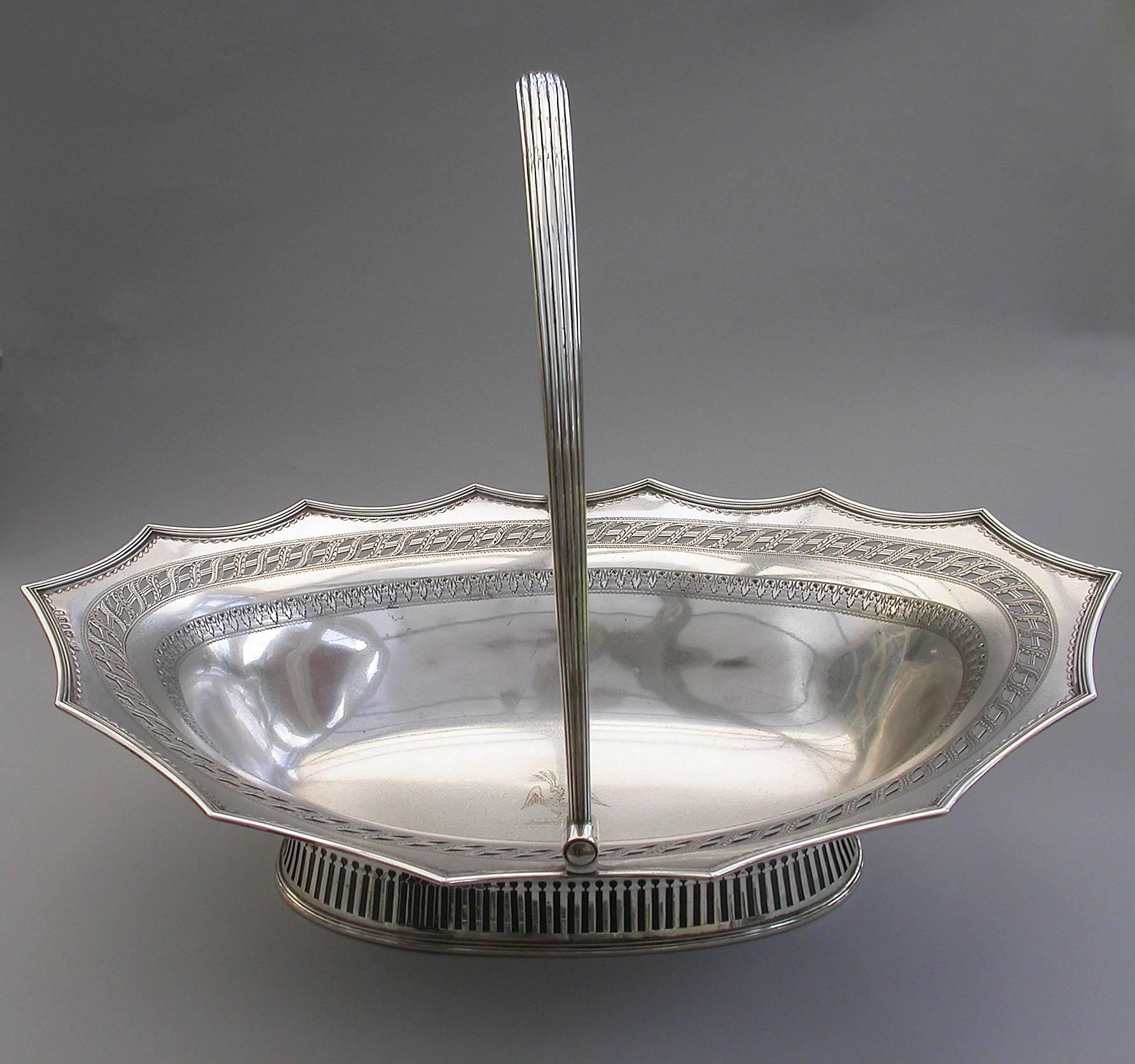 A very fine quality George III silver cake basket of oval form with pierced collet foot and reeded swing handle, the shaped scalloped rim with applied reeded border and decorated with bands of pierced and bright-cut engraved leaves and scrolls, the