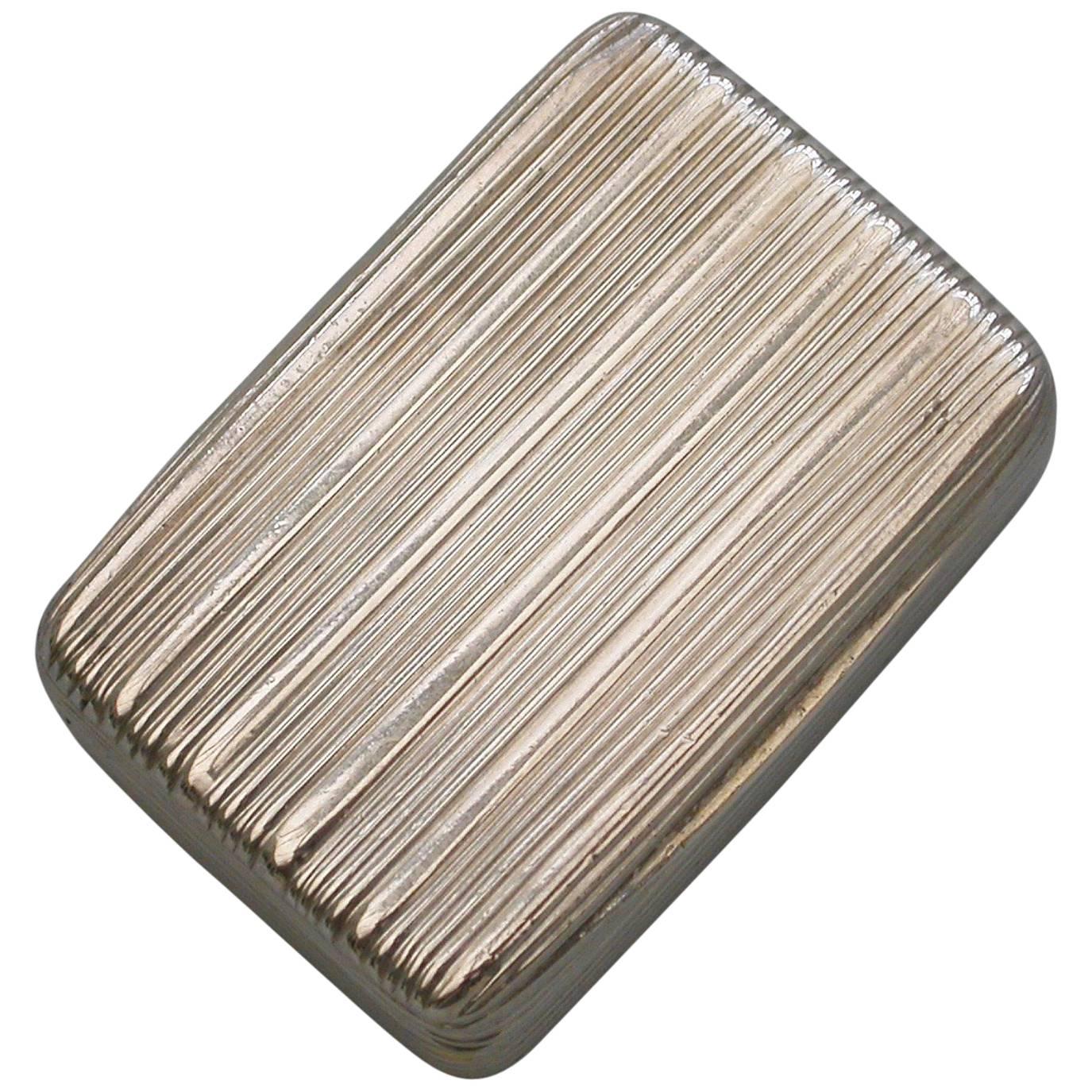 A rare George IV London made silver Vinaigrette of rounded rectangular form with plain reeded decoration to the base, lid and sides. The silver gilt interior with finely pierced and engraved grille depicting an open book and a quill pen amongst