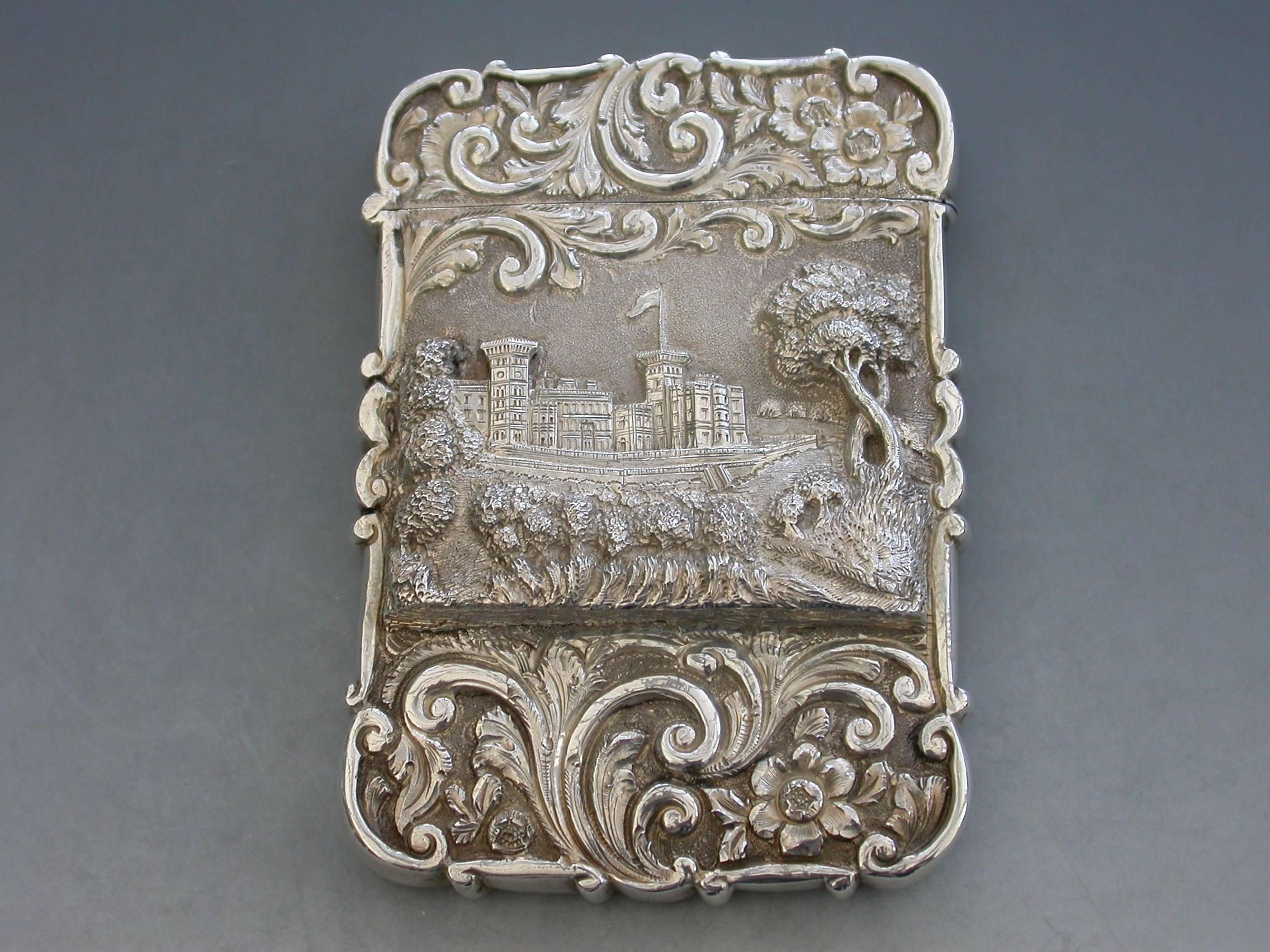 An extremely rare Victorian castle-top card case of shaped rectangular form with chased and embossed foliate scroll decoration, the front with a scene depicting an unusual view of Osborne House from the Shrubbery in high relief. The reverse with a