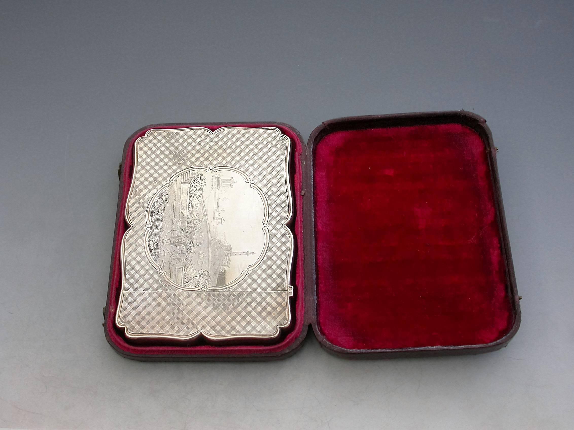 A rare Victorian silver card case of shaped rectangular form with hinged lid, the front and back decorated with tartan style engraving, the front engraved with a scene depicting Calton Hill in Edinburgh, a lady riding side-saddle on a horse to the