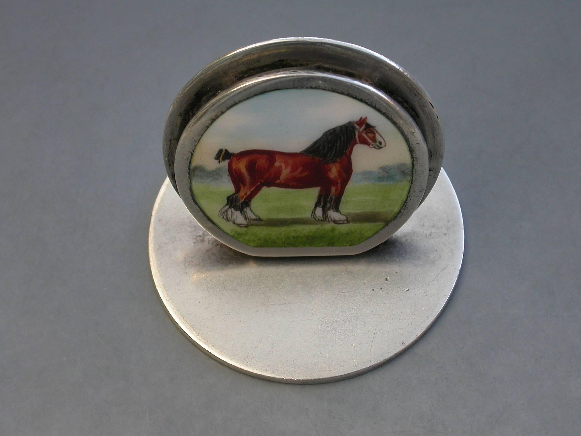 A fine and extremely rare Edwardian silver and enamel menu holder of double-disc form on a circular base, the sprung circular front panel finely enameled with a Shire Horse in a landscape scene.

By Sampson Mordan & Co, Chester, 1906

In good