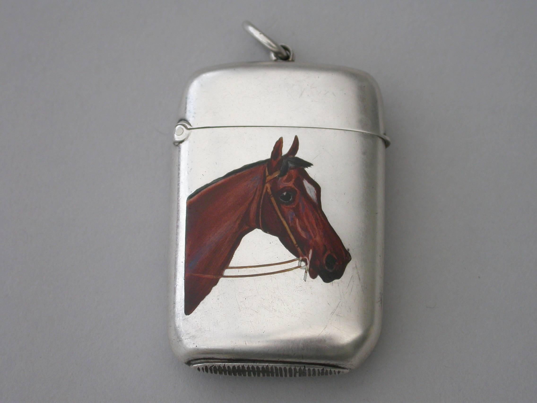 A good quality Victorian silver and enamel Vesta case of rounded rectangular form with sprung hinged lid and attached suspension ring, the face finely enameled with a depiction of a thoroughbred horses head. The reverse engraved with contemporary