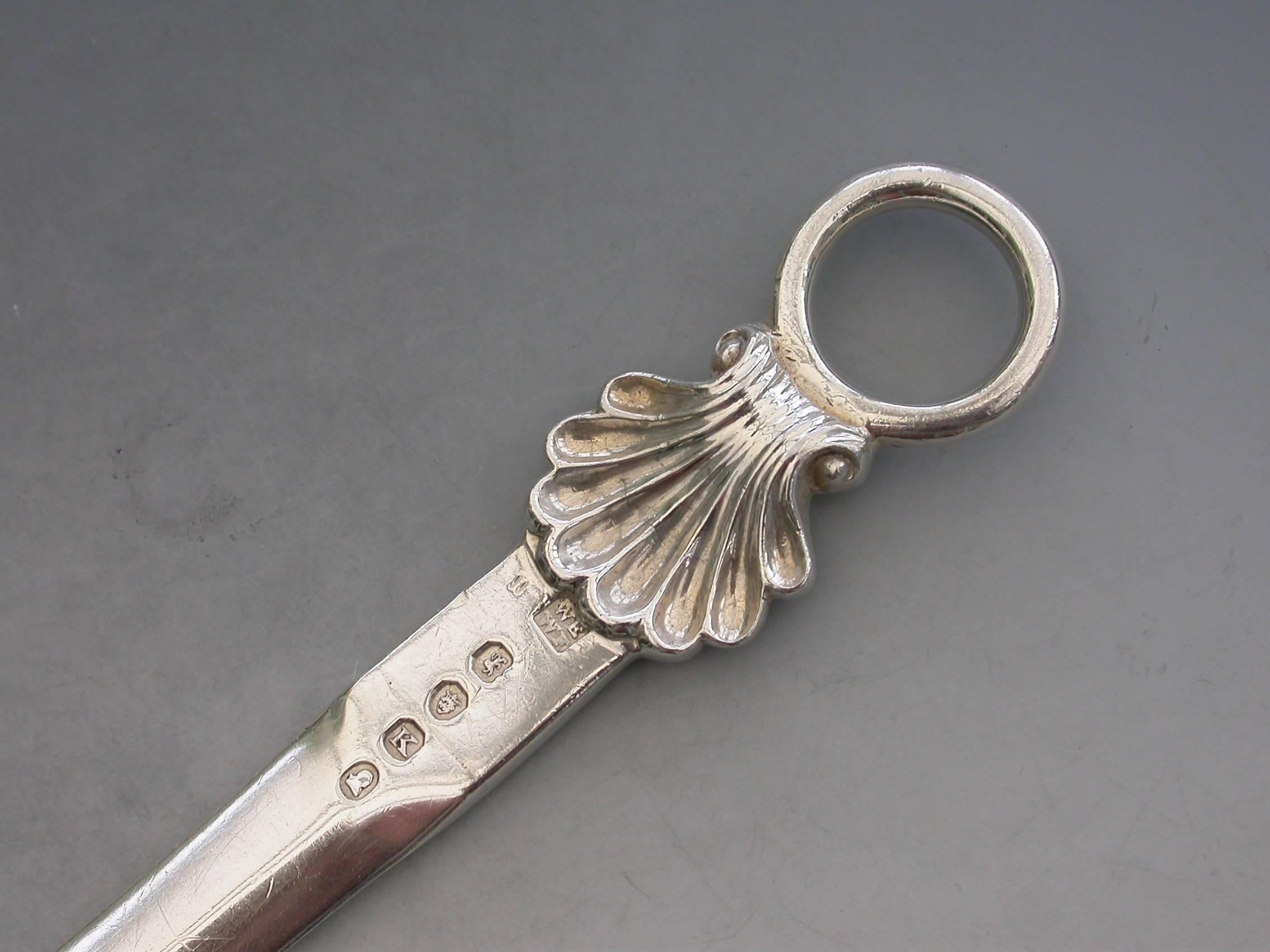 A good quality George III heavy cast silver Meat Skewer with plain tapering blade and shell and ring terminal.

The blade engraved with a crest of a Pelican vulning (that of many families).

By Eley & Fearn, London, 1805

In good condition