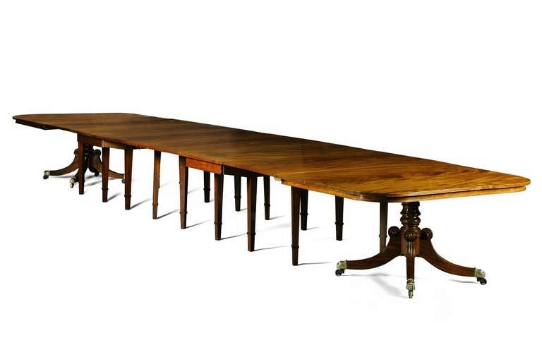 A Regency mahogany dining table from Durham Cathedral.
This unusual and versatile Regency mahogany extending dining table is constructed in four sections and has a reeded edge to the rounded rectangular top. The tilt-top end sections are raised on