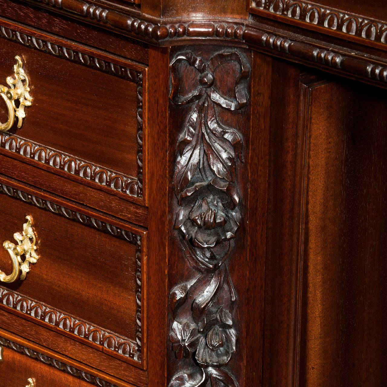 A fine late mahogany Chippendale style pedestal desk with carvings to the returns and cupboards to the sides.