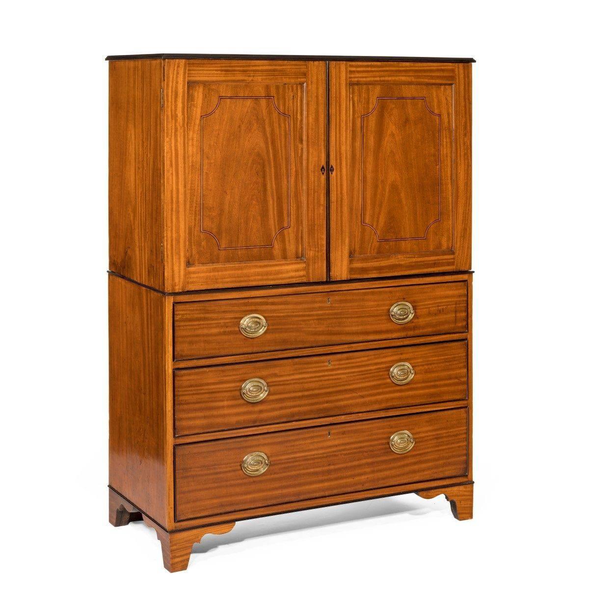 This satinwood and ebony ship’s cabinet has an upper section with two cupboard doors opening to reveal eighteen graduated small drawers with ebony handles and stringing.

The lower section comprises a chest of three long drawers, similarly edged and