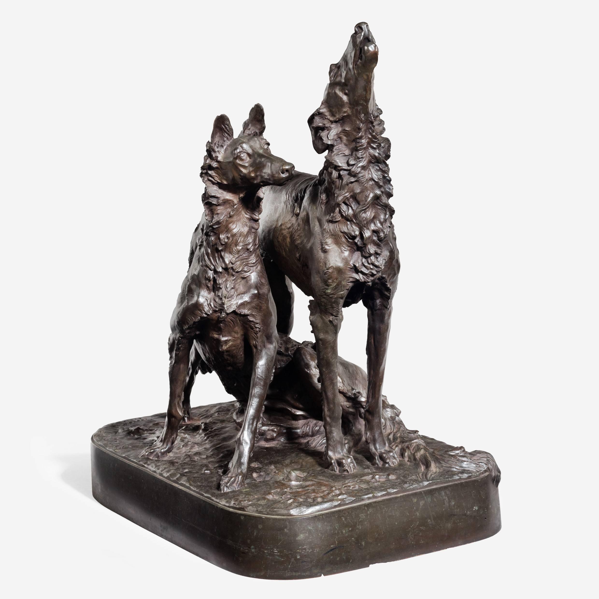 An attractive patinated bronze group of two hounds by Mark Thomas, showing one dog standing with muzzle raised in a howl and the other seated between its legs. 

Signed: Mark Thomas, stamped Thiebault fres. Foundry, Paris.