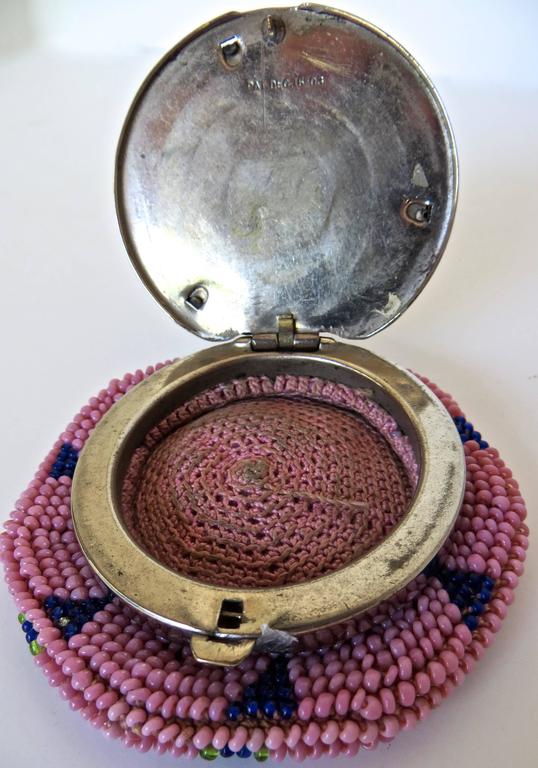 A particularly fine quality rare and difficult to find Native American silver plated beaded coin purse, with an image of an Indian chief. The beading is of an exquisite pink color and detail. I conclude that it is manufactured by 