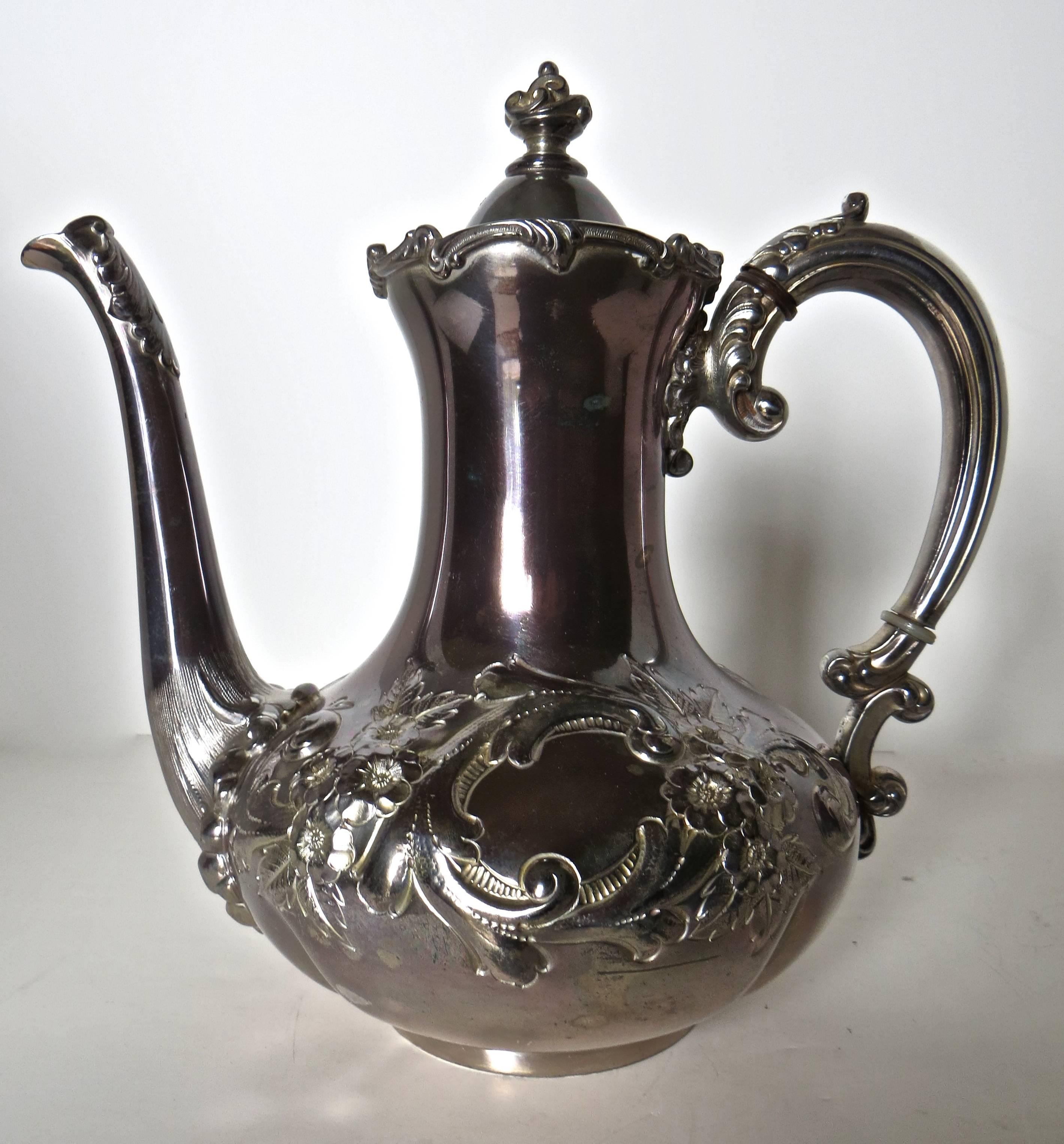 Victorian silver plated tea service with heavy repousse Art Nouveau floral decorations of flowers and vines. The pieces consist of the following:

Tea pot 9