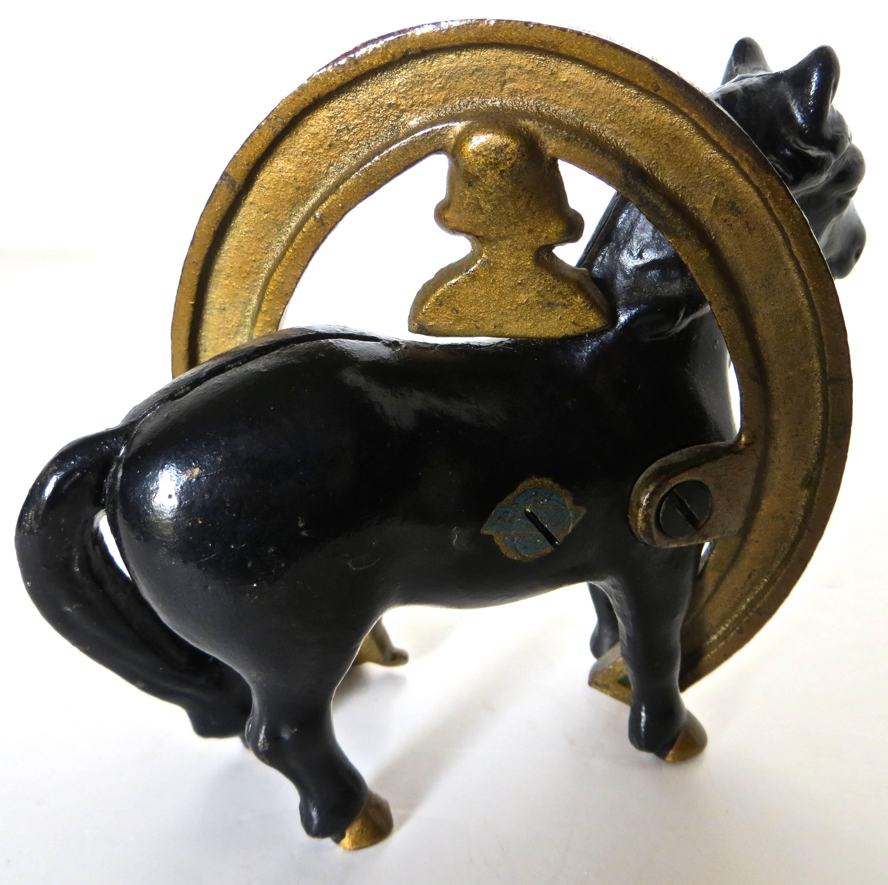 The cast iron bank pictured is called "Good Luck" Horseshoe, as stated and embossed on theside of the horse. It depicts Buster Brown and Tige (prominent children's characters of that time) who are attached to a horseshoe which is wrapped