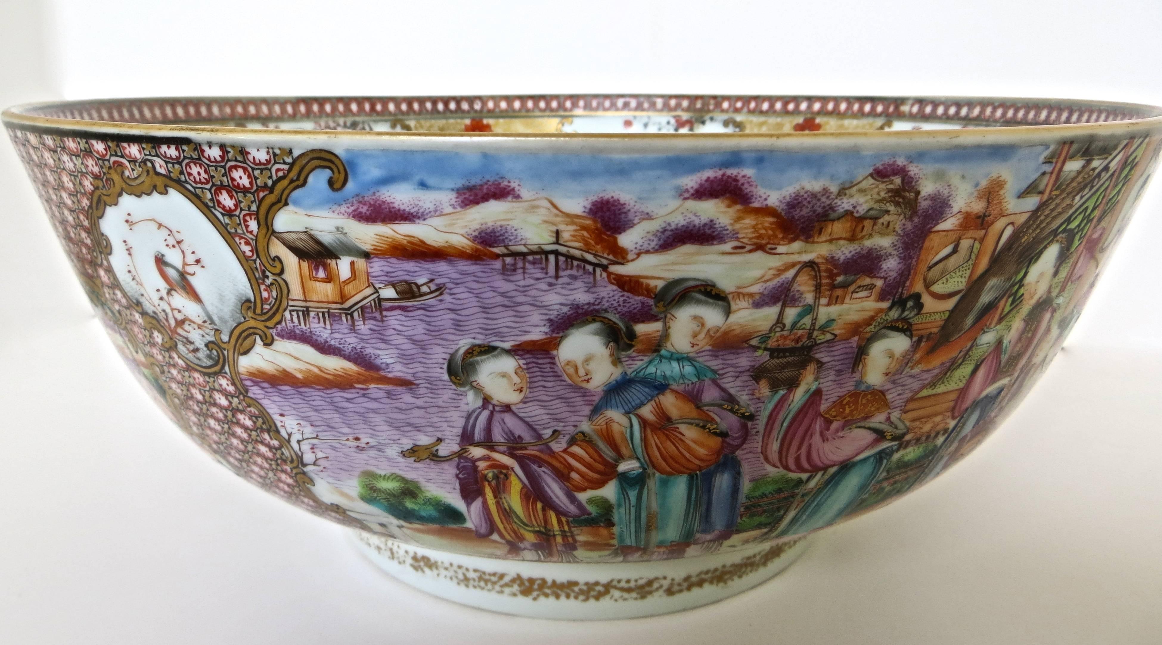 Fine Ch'ing dynasty export Famille Rose large punch bowl, hand-painted porcelain, in very colorful everyday scenes of the upper socioeconomic level of Chinese society during the period of the late 18th century (circa 1785). Fruit, floral, and avian