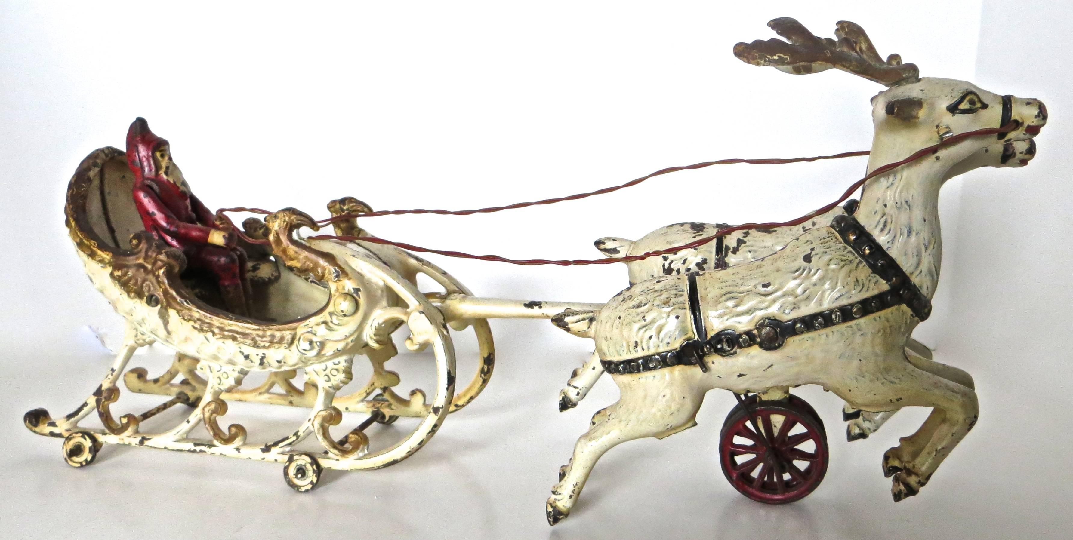 This is a very difficult to find cast iron Christmas toy made just after the turn of the century by the Hubley Manufacturing Company, Lancaster, Pennsylvania, featuring Santa Claus in a sleigh being pulled by two reindeer. It is is the double