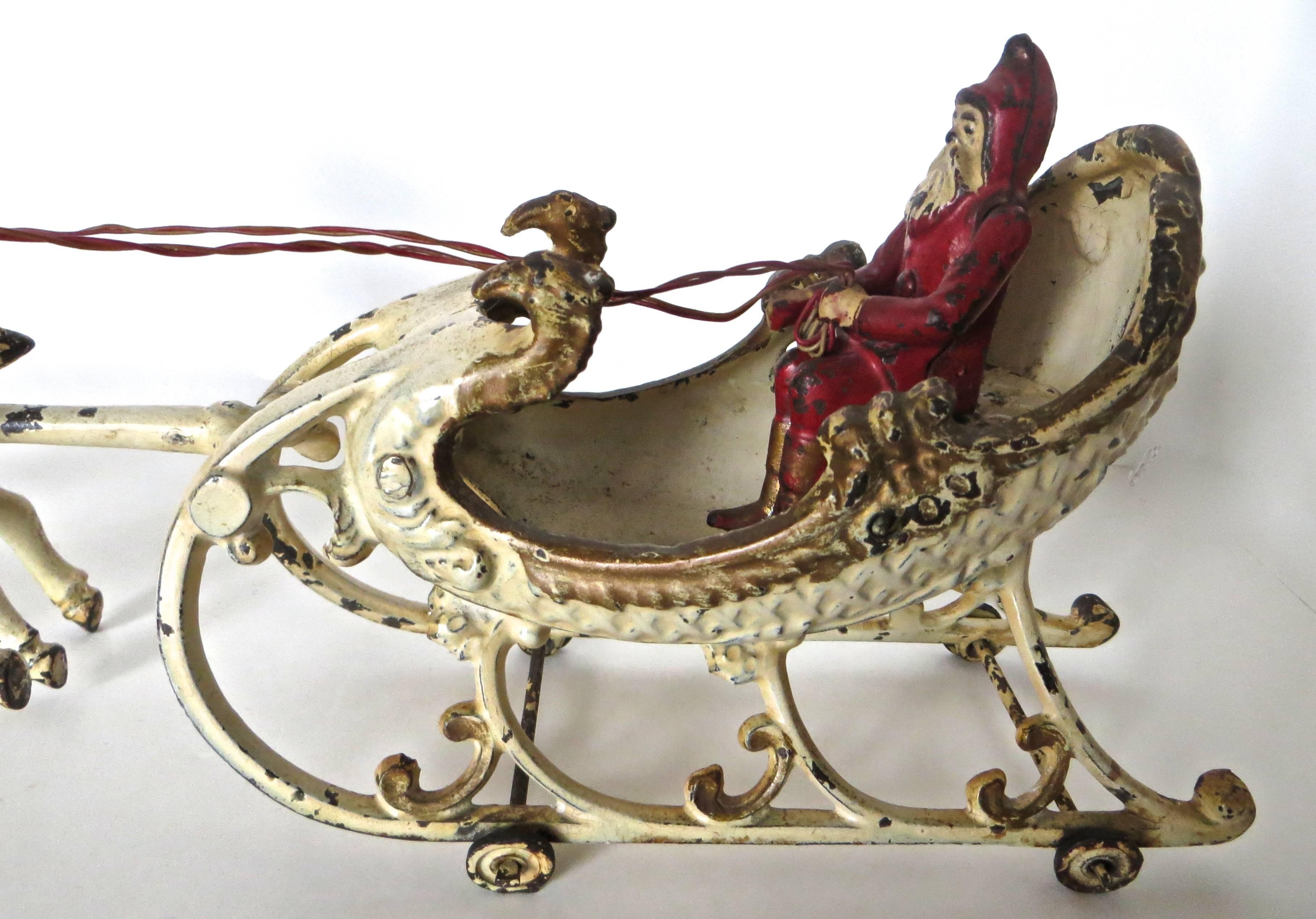 Folk Art Santa in the Sleigh with Two Reindeer by Hubley, circa 1900