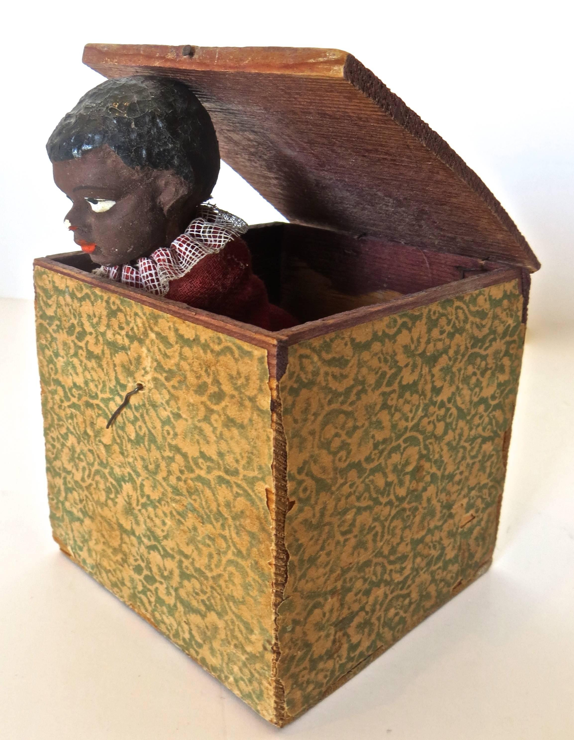 Jack-in-the-box toys date from 15th century England, but became very prevalent from the middle of the 19th century until present day.

This rare black themed toy Jack-in-The-Box, circa 1890, is in all original hand paint and condition with no