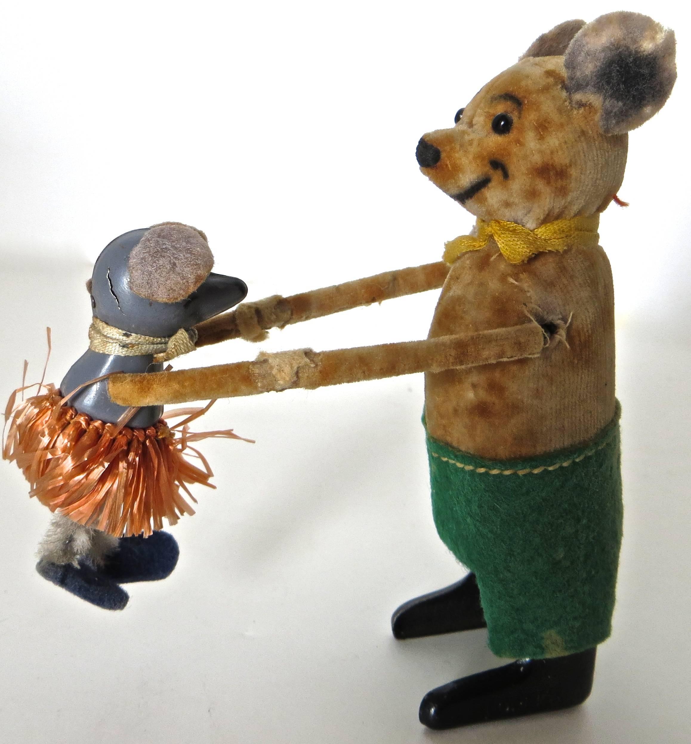 One of the most amusing of the Schuco clockwork toys, this rare windup toy, when wound, starts the bear dancing with his partner, the baby mouse. He spins around dancing in both directions while at the same time raising the mouse up and down. It is
