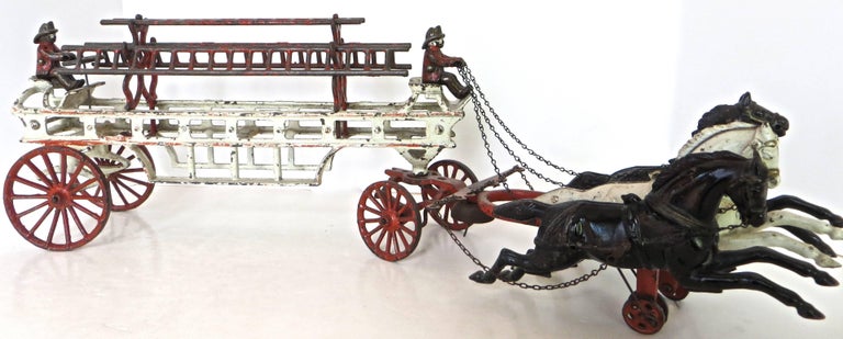 Nicely painted large cast iron, horse drawn fire toys are much sought after by collectors. The piece becomes special when it is all original, because of the abuse that might have occurred from the rough play. Over the years the cast iron figures