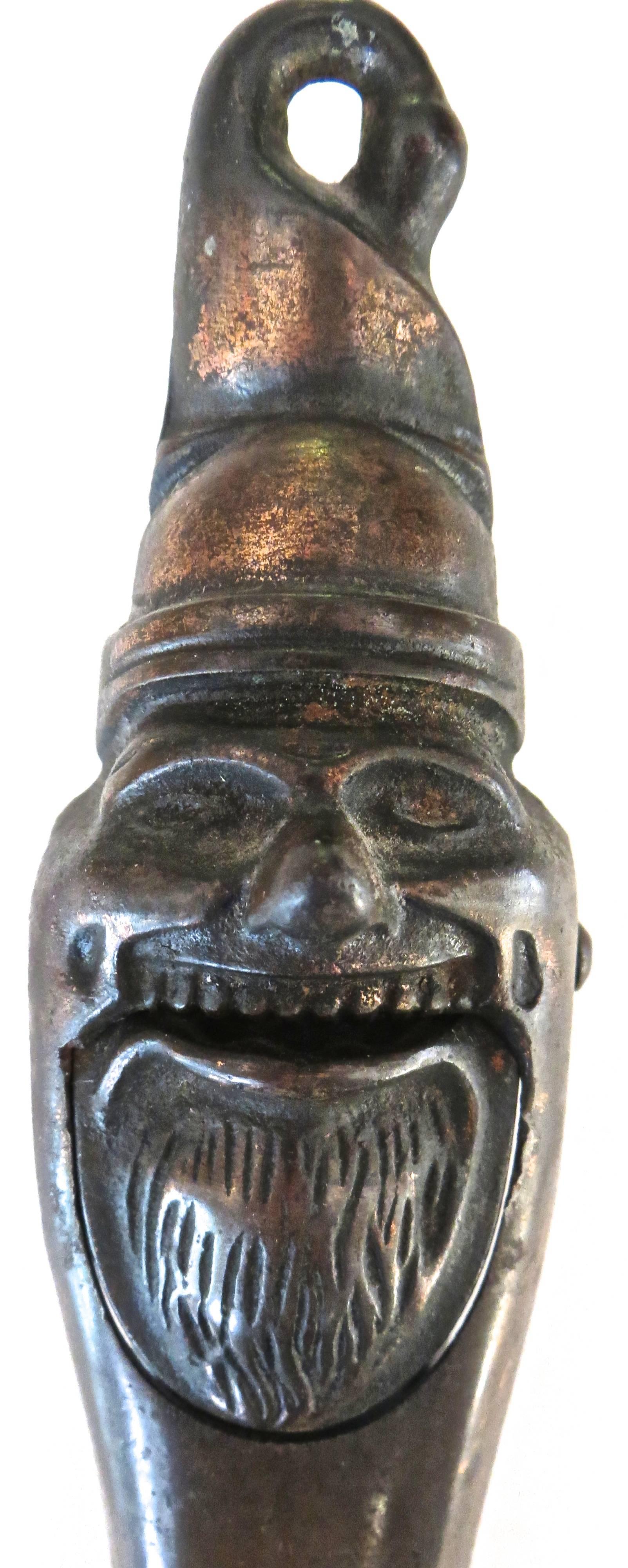 This copper-plated cast iron Santa Claus nutcracker was manufactured in England, circa 1880s. It pivots on an iron pin. The face is very finely cast detailing Santa's beard and facial characteristics. When open Santa's mouth opens wide ready to