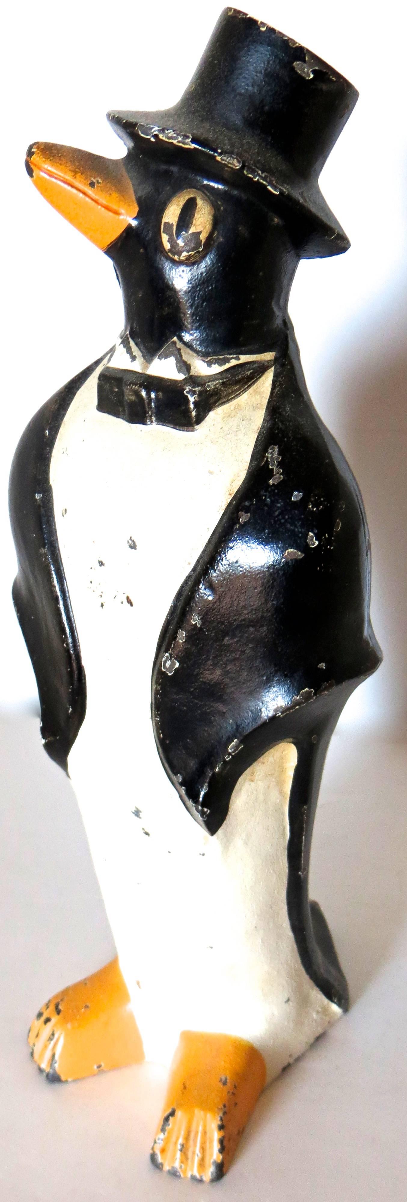 From my personal collection I am offering this whimsical caricature of a penguin dressed in a tuxedo referred to as "Penguin with Bow Tie and Top Hat". This cast iron two piece full figured doorstop was manufactured by the Hubley