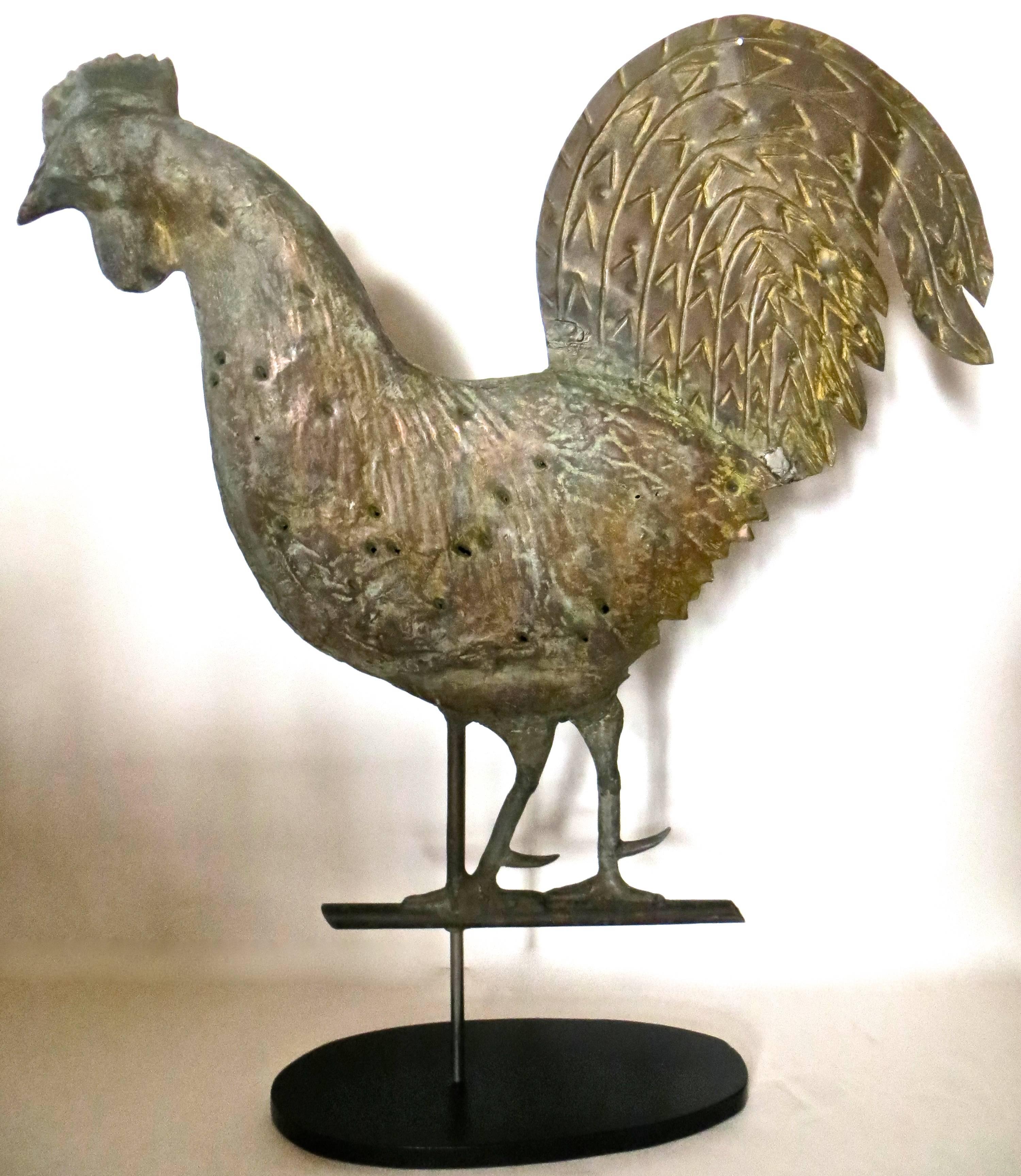 Late 19th century, classic form molded rooster copper weathervane with sheet brass tail and zinc legs, which are supported by the original
13 1/2