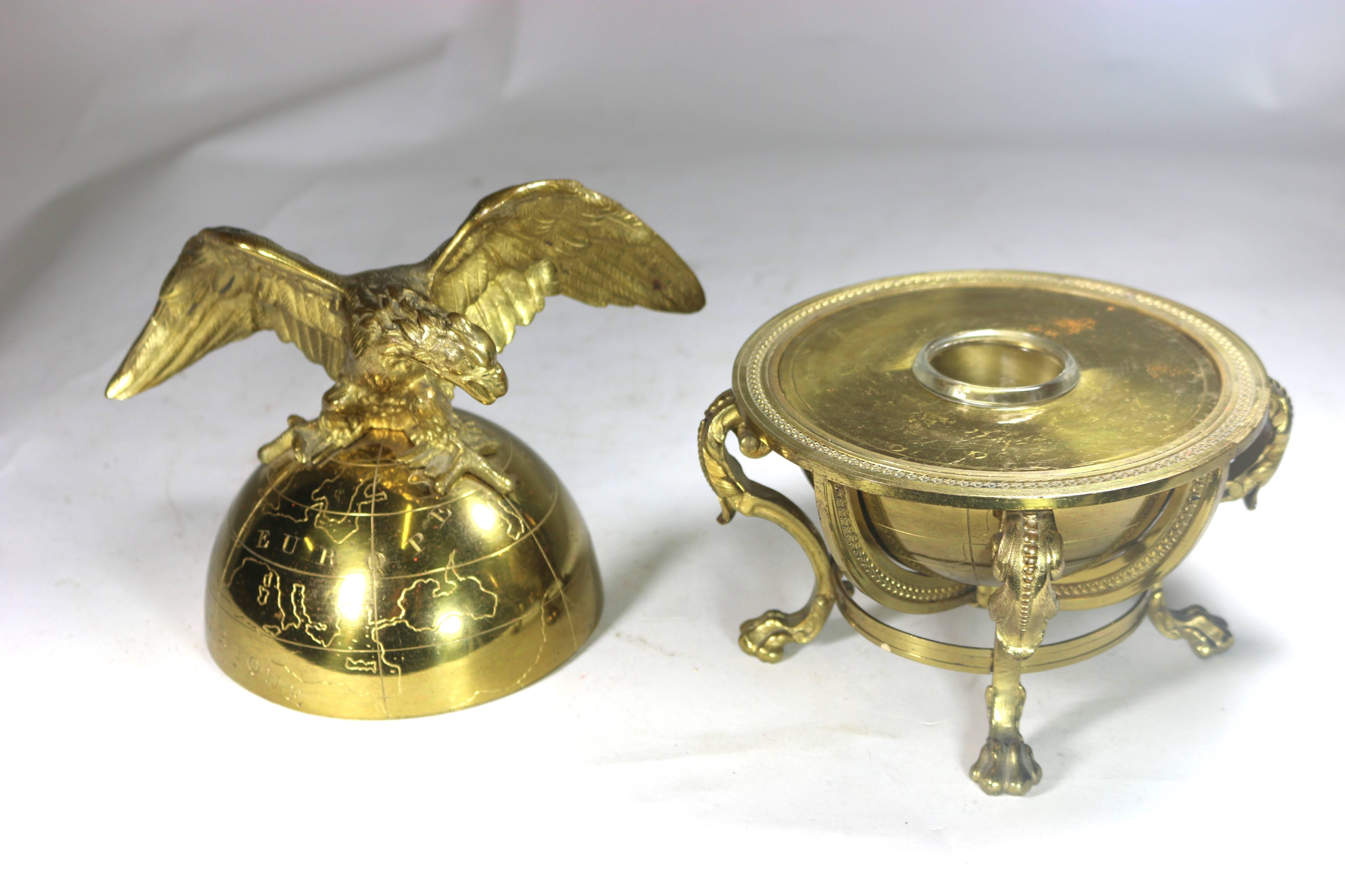 Superb large neoclassic brass globe with eagle atop which opens to a crystal ink holder which adorns a desktop, tabletop or book shelves with panache!! 
Beautiful repousee details with paw feet in a finely articulated globe holder-with Makers Mark