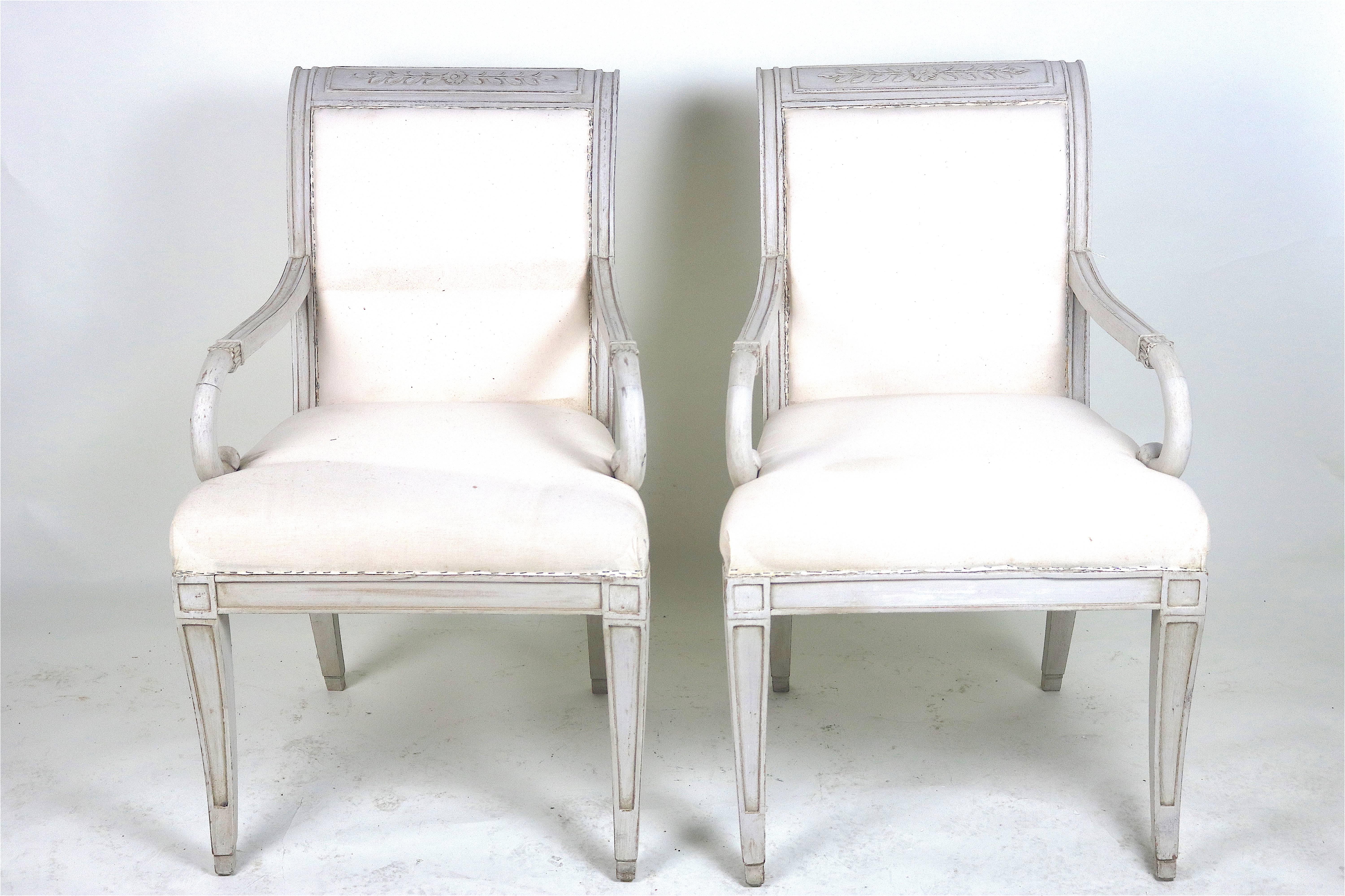 Gustavian graceful pair of detailed carved wood painted armchairs with beautiful worn patina and lovely hand-carved details on the back rail, arms, and legs.
A beautiful pair of chairs to place in your inspired decor.
Covered in muslin fabric ready