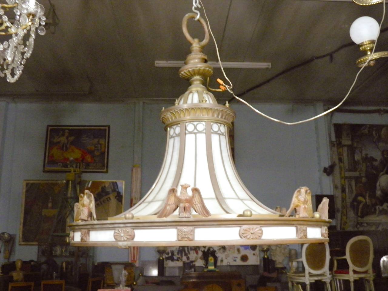 A 1900-1929 rare magnificent grand scale lobby chandelier by Edward F. Caldwell, a tour de force of American foundry cast and hand finished bronze and leaded glass fabrication, very heavy aged bronze vintage glass chandelier light pendant, featuring