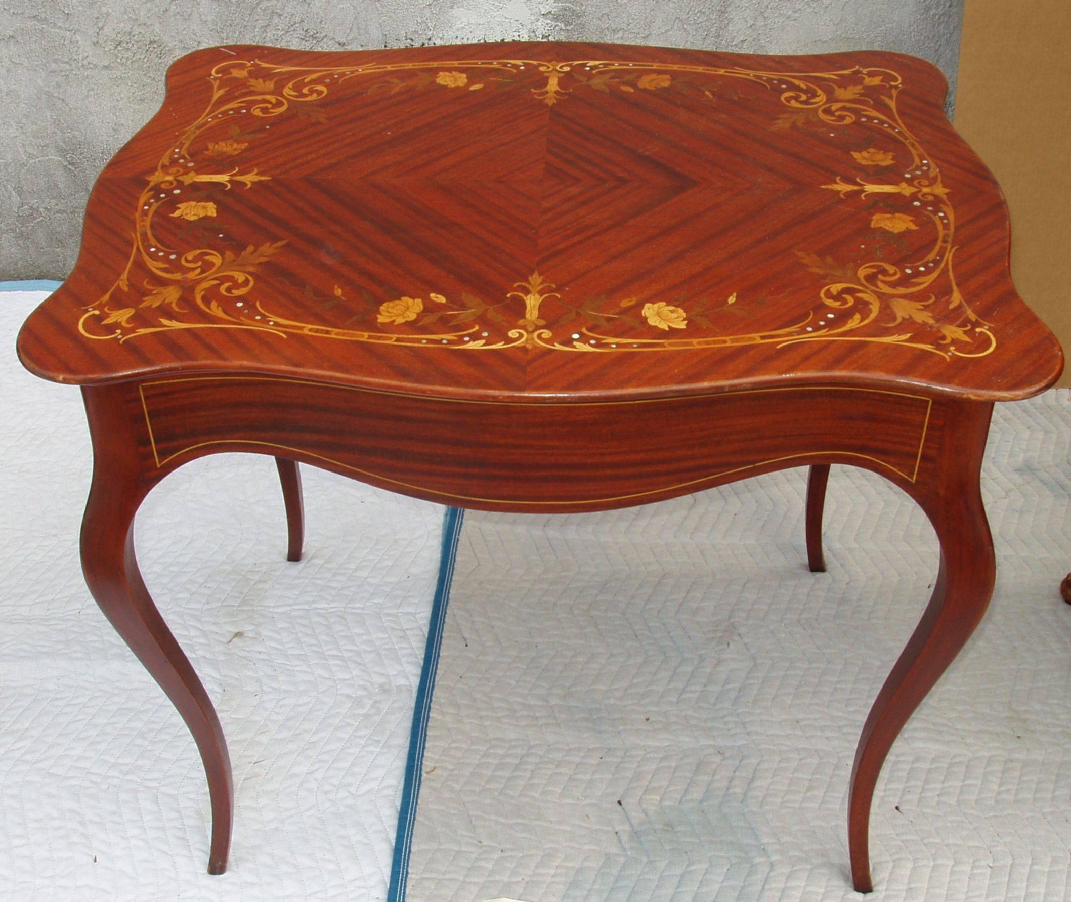 A beautiful Art Nouveau side table or ladies desk in the majorelle style with lovely exotic wood floral marquetry and mother-of-pearl inlay top, inlay trim around apron. Circa 1920