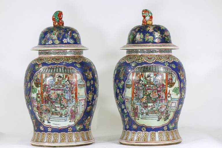 A stunning cobalt blue pair of famille rose Chinese porcelain ginger jars urns with foo dog covers, decorated with figures and animals in a mountain and sea landscape, banded pattern at base and shoulder, Qianlong mark on base.
Provenance: Assembled