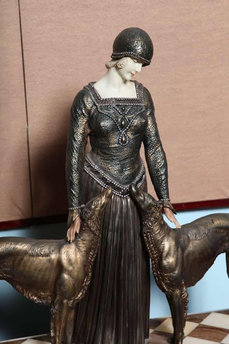 Exquisite French bronze figural group, after the 1925 Demetre H. Chiparus (Romanian, 1886-1947), Les Amis de Toujours (Friends Forever). Depicting a beautiful fashionable lady flanked by borzoi hounds, set on an onyx plinth base, with a very