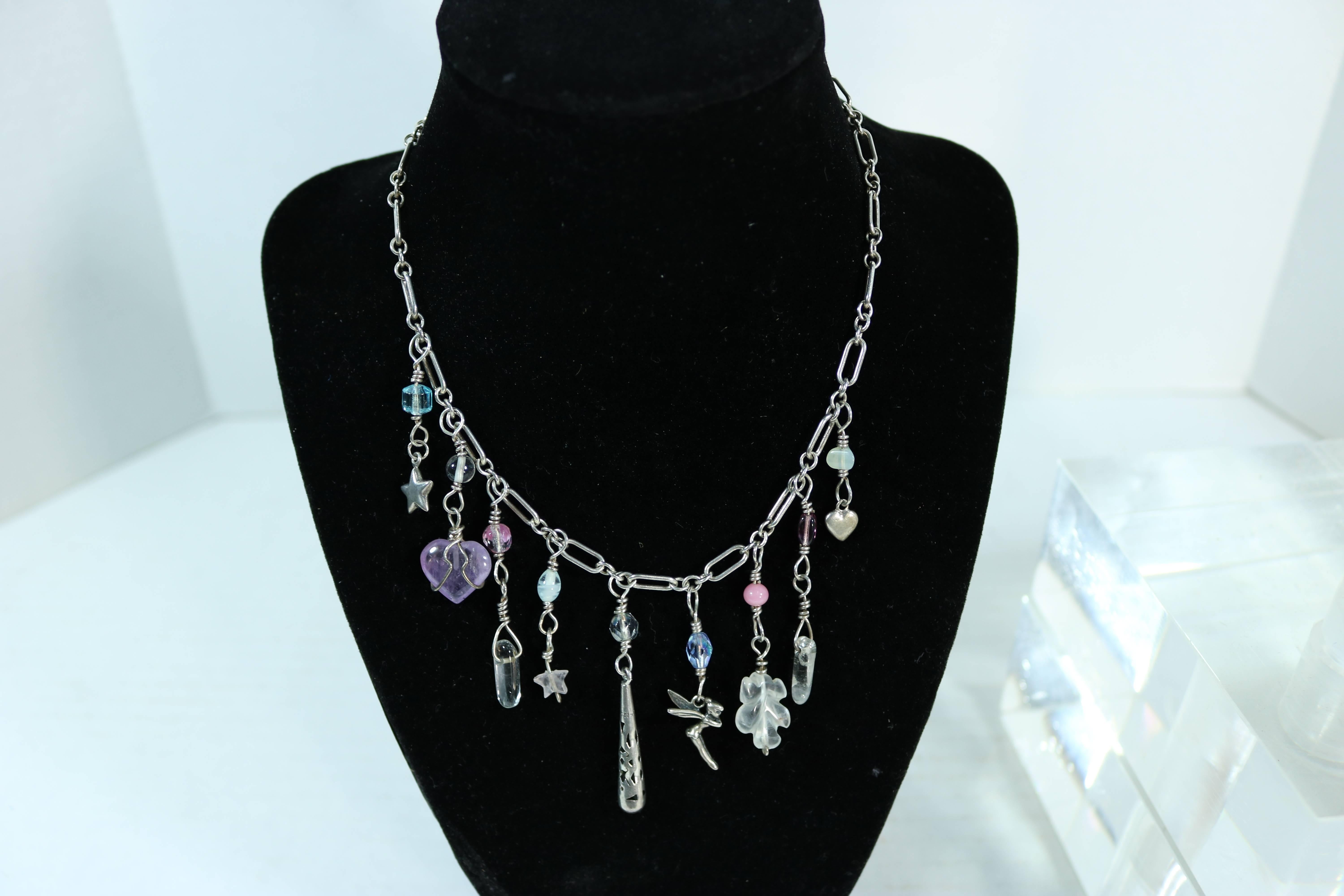 A beautifully fabricated most ‘Charming’ necklace and bracelet with fairies, amethyst hearts, teddy bear, amulets, crystals, stars dangling from a sterling silver neck chain and a sterling bangle bracelet.
Bracelet marked 925, TS-30 necklace marked