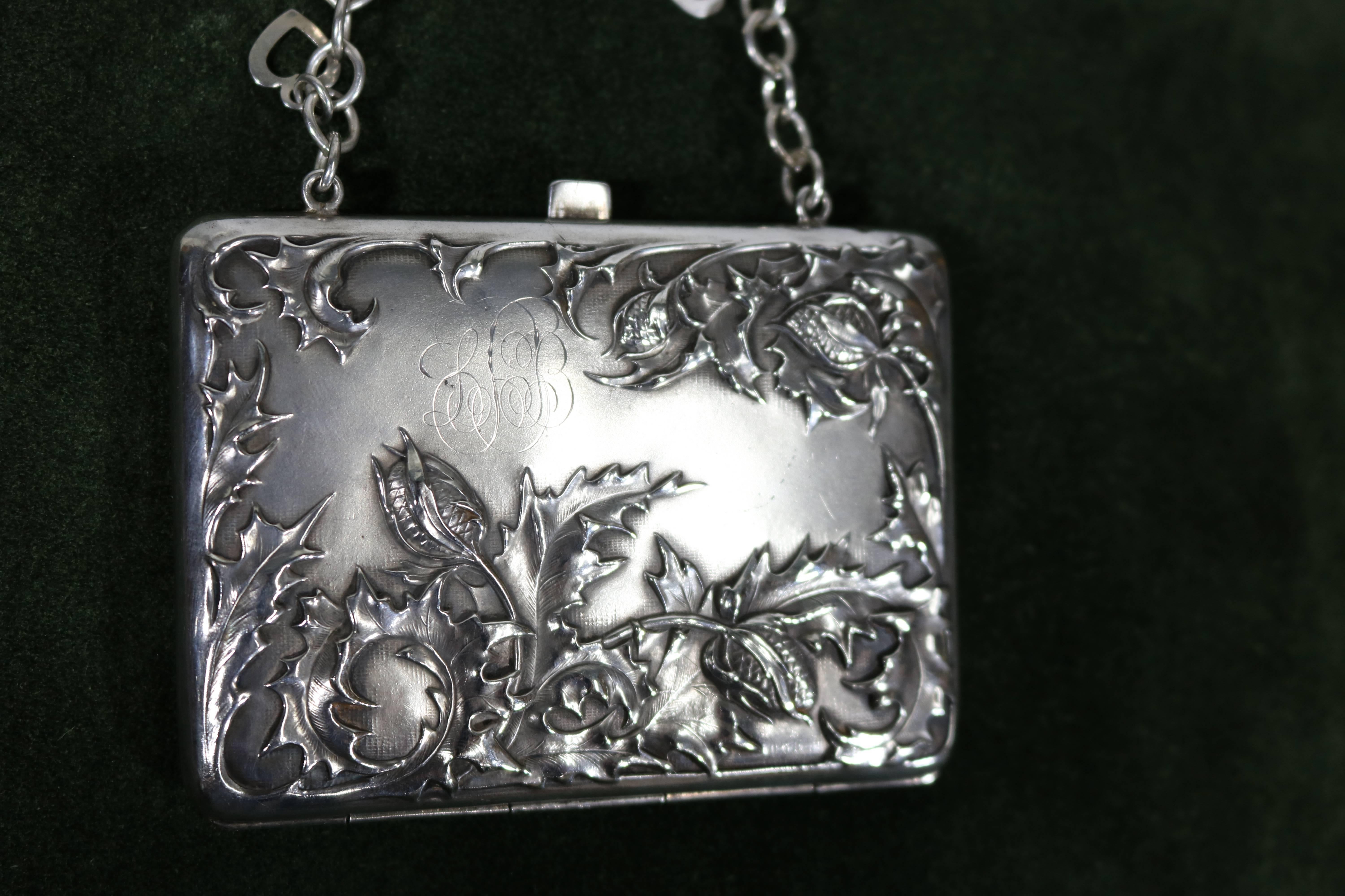 Sterling silver chased repoussé purse or card case with double sided lovely flora & fauna design. Marked sterling on interior frame, light blue linen fabric interior pockets--(some staining on linen--) rectangular and hinged. Has lightly engraved