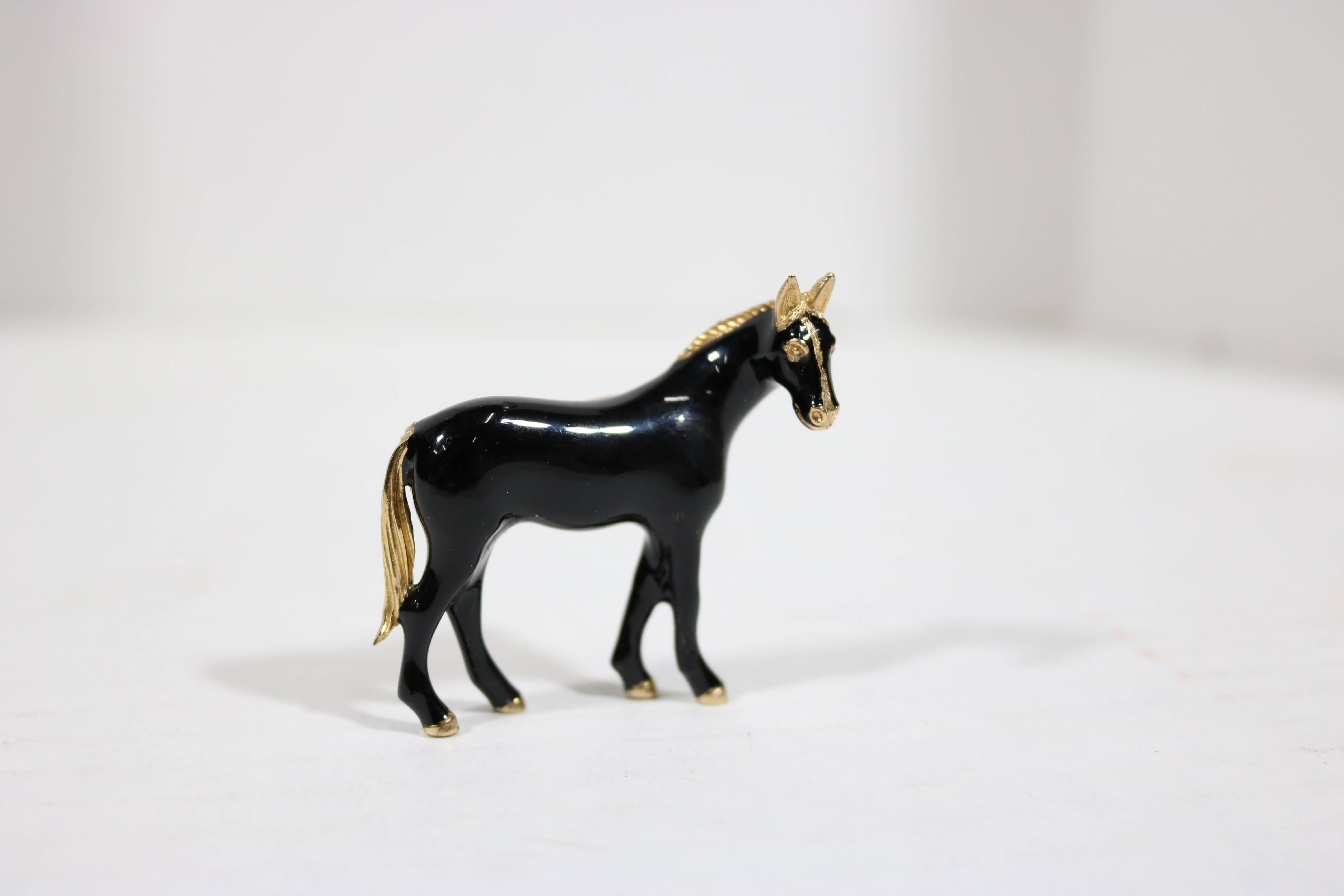 Mid-20th century distinctive Black Stallion brooch with his head turned to look at viewer-skillfully fabricated and designed very handsome jet lustrous enamel with gold plate trim brooch with interior gold circle design, marked, copyright Ciner on