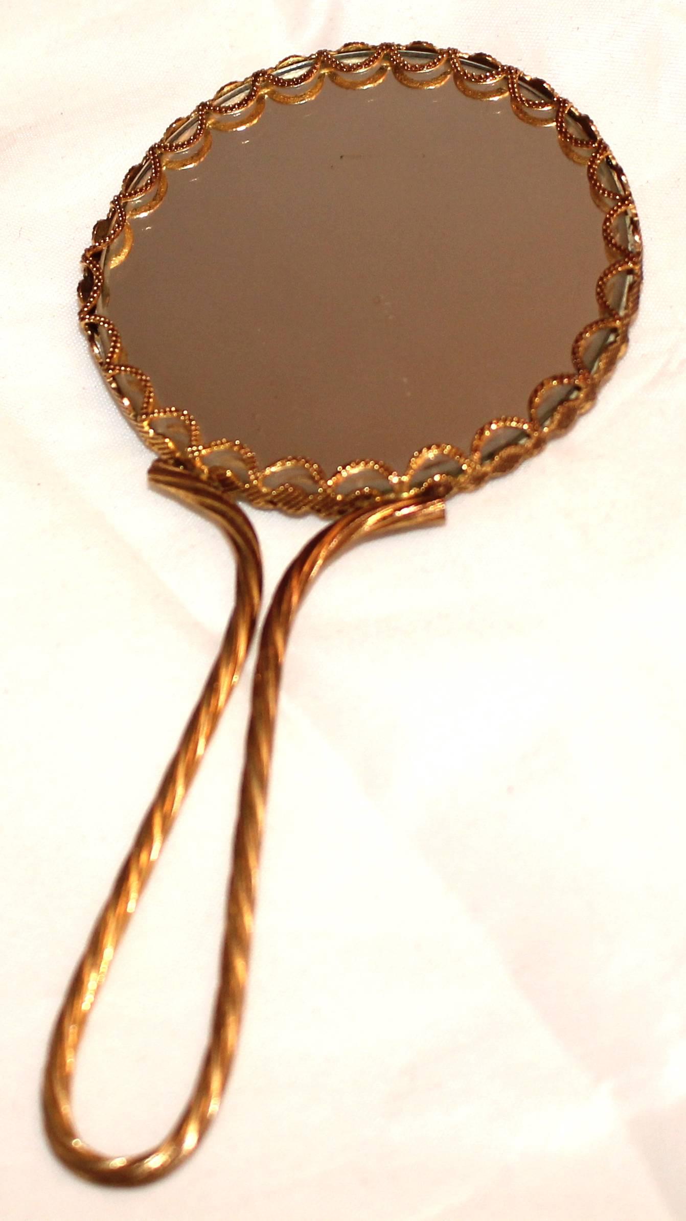 An elegant hand mirror, a gilt French gentleman kissing a ladies hand, Limoges signature in gold on cobalt blue porcelain with gilt metal trim on both sides with gilt metal loop handle. Good condition.

 