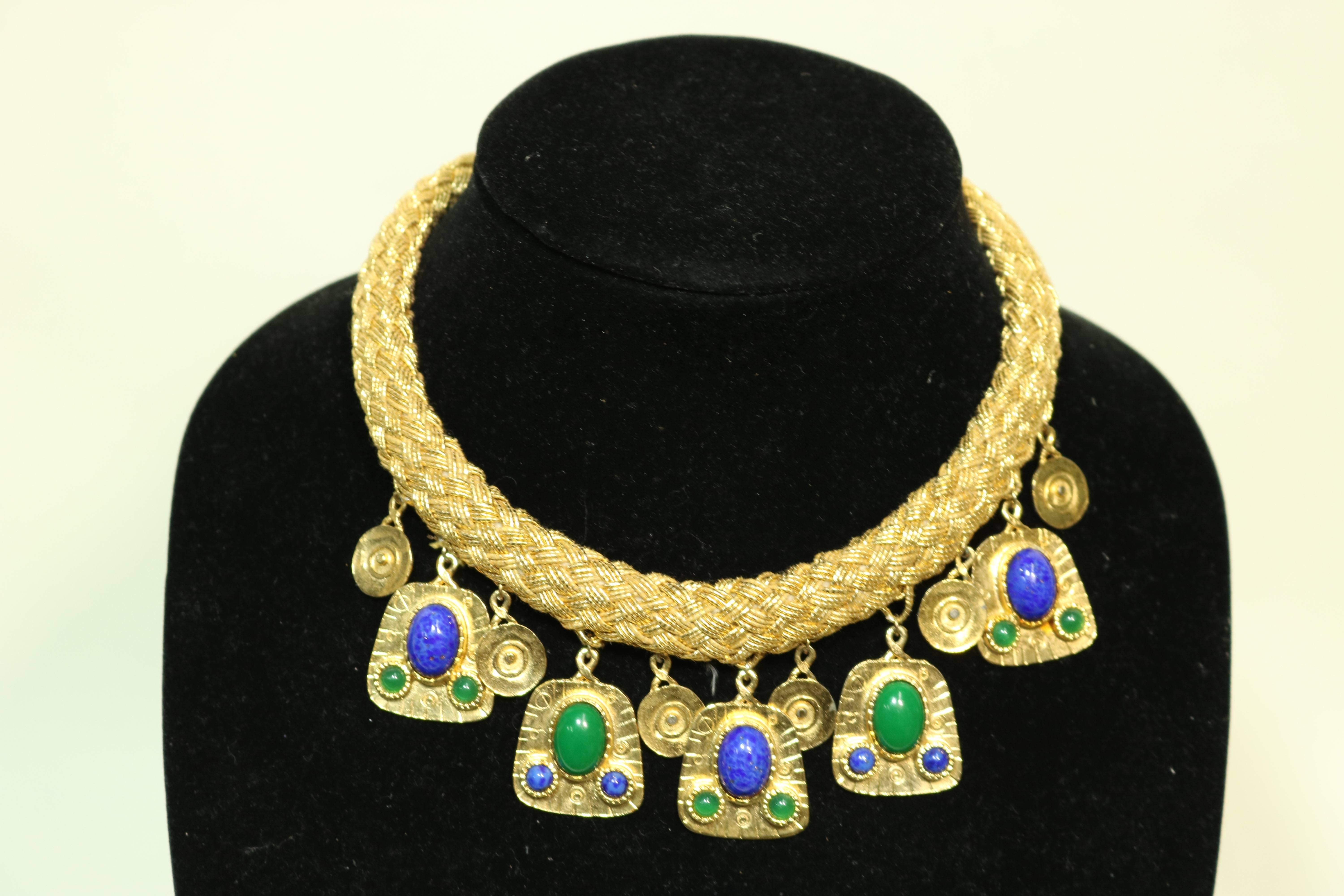 Stunning Egyptian style woven gold thread collar necklace with heavy gold plate articulated drops laden with alternating malachite and lapis cabochons
and circular drops.
An exotic look makes for a striking vision when worn.