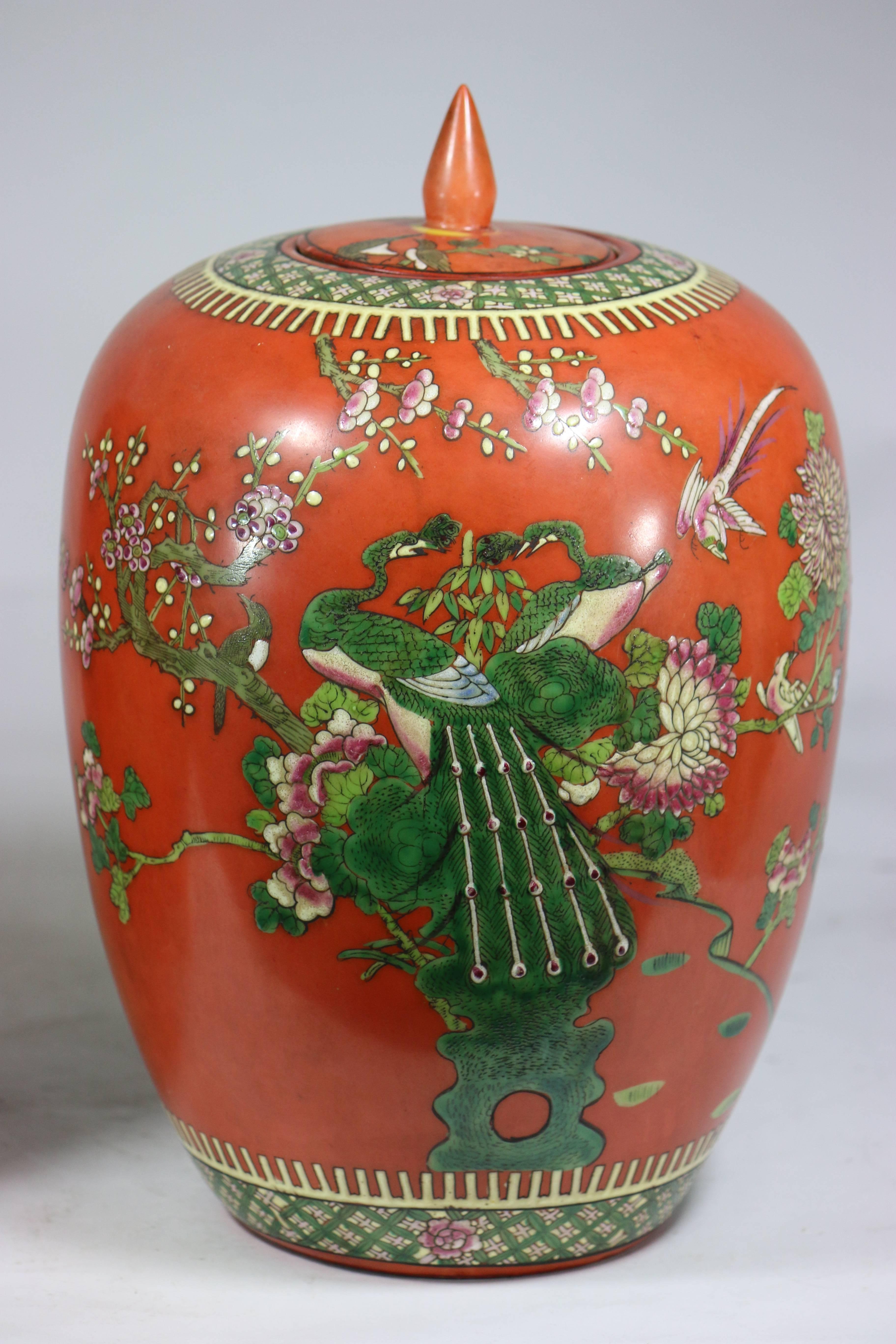 A pair of beautiful highly decorative Chinese lidded ginger jars in the most exquisite dynamic colors of Lucious Persimmon and Emerald Green with a reign mark.
 