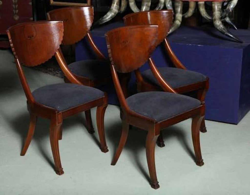Stunning set of four early 20th century Biedermeier style armless chairs -figured beautiful mellow patina burl wood with a scallop back design, Klismos legs, an inlay black border delineated design around the chair silhouette ending on the inside